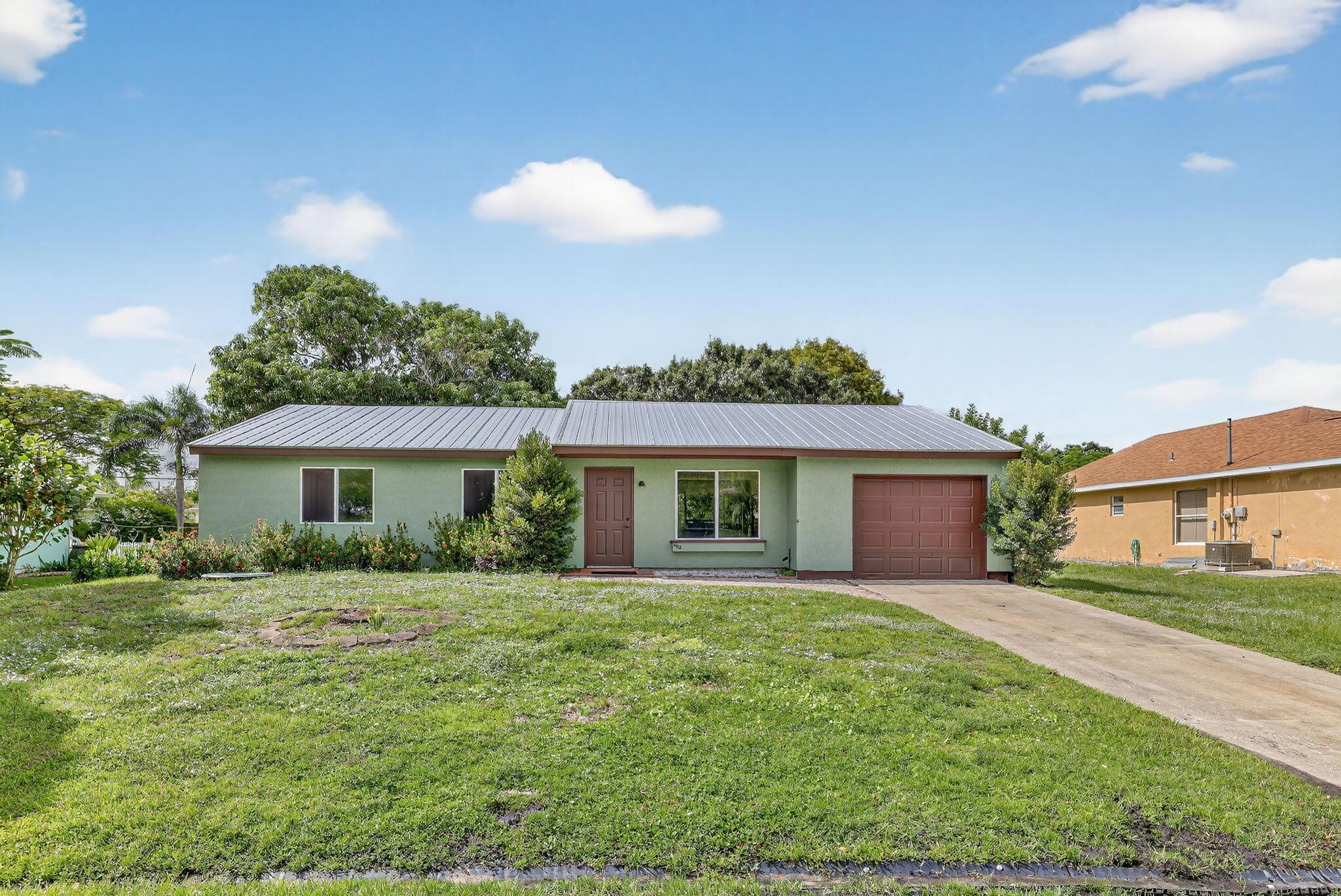 Move in ready! This beautifully updated 3-bedroom, 2-bath home is located in the heart of Port St. Lucie, offering the perfect mix of comfort, convenience, and style. Featuring laminate and tile flooring throughout, a spacious open layout, and a large backyard ideal for relaxing or entertaining under the Florida sunshine. The newer metal roof provides peace of mind, while the unbeatable location keeps you close to shopping, dining, hospitals, parks, and with easy access to I-95 and the Turnpike. Only first month and security deposit required an amazing value for such a great home! Don't wait  schedule your tour today!