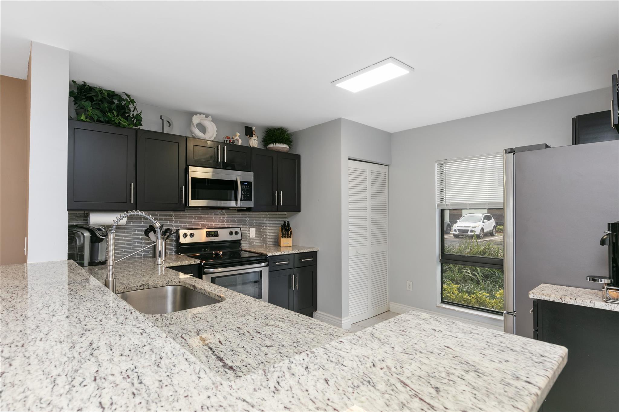 All financing types welcome - FHA, VA, & low down conventional loans accepted! This beautifully updated, move-in-ready townhome in River Oaks offers incredible value in Boca Raton. The updated kitchen features granite countertops, stainless steel appliances (new refrigerator & microwave in '24) & a stylish glass tile backsplash. All bathrooms have been tastefully renovated, & vaulted ceilings in the upstairs bedrooms add a bright, open feel. Enjoy a screened-in patio w/ a tranquil Koi pond (removable at buyer’s request). Additional features include a '20 A/C, 2 storage rooms, 2 assigned parking spaces & ample guest parking. Located in an A-rated school district. The reasonable HOA covers cable, internet, insurance, roof & pool. Don’t miss this opportunity to make River Oaks your new home!