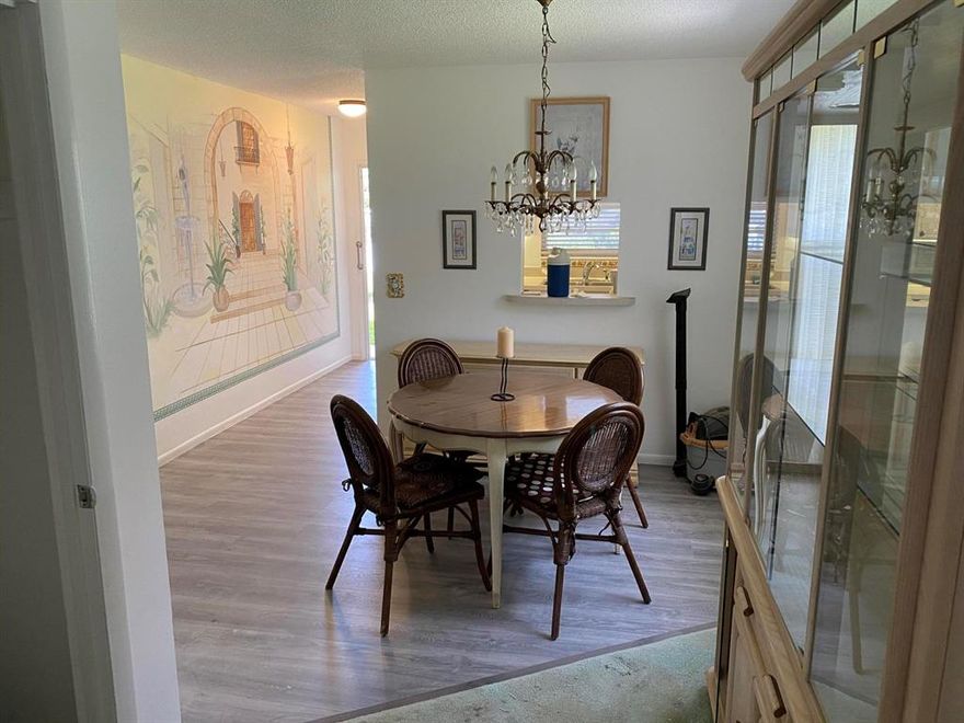 Back on the market after a quick re-fresh featuring new floors through out entry way, kitchen and dinning room.  Clean and ready to go! Enjoy your home in a serene and tranquil setting while sitting out in your spacious solarium always knowing you can be as involved as you wish. Great clubhouse boasting a library, pool, billiard room, craft room, workshop room, bocce court, ping pong, meeting space, workout area and shuffleboard just a walk away.  Washer and Dryer on the same floor.