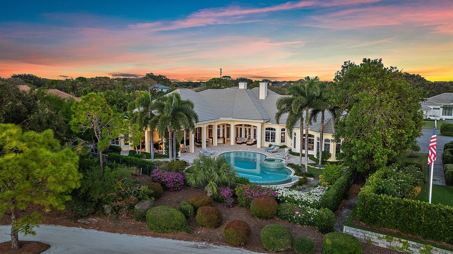 Nestled in the prestigious Jupiter Hills Village, this residence exemplifies the apex of luxury indoor-outdoor living. A custom-built estate, it stands as one of only eleven exclusive homes on the renowned Hills course, a golf course steeped in history, currently ranked 4th in the state and consistently in the Top 100 nationwide for over 3 decades. Designed for seamless entertaining, the outdoor bar and fireplace offer a welcoming retreat for year-round gatherings. Expansive windows and electronic sliding doors blur the boundaries between the family room, kitchen, and outdoor spaces, connecting effortlessly to the fireplace, bar, grill, and poolside terraces.