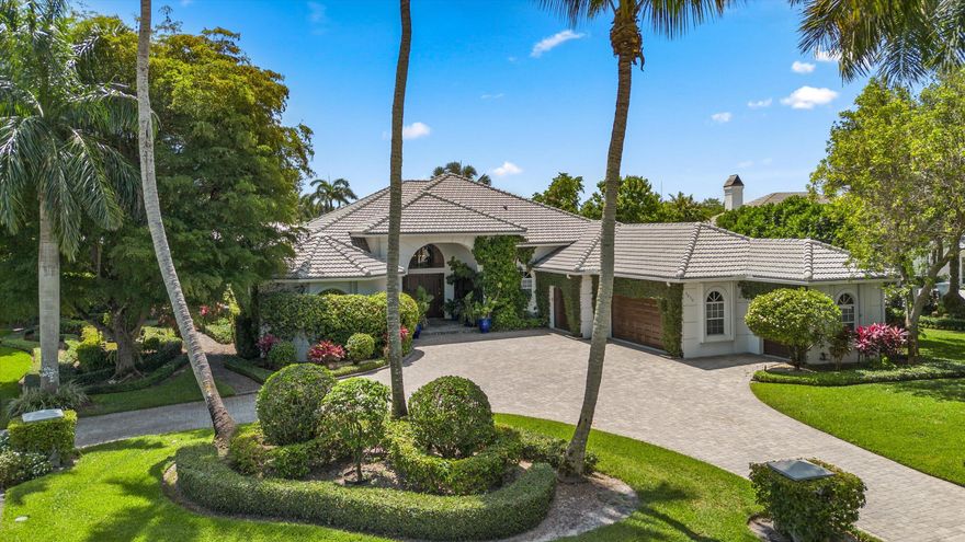 Nestled on a prime oversized corner lot in the coveted Equestrian Club Estates, this exceptional 3-bedroom, 3.5-bath residence is ideally positioned just a short golf cart ride or walk from the show grounds of Wellington International.  Situated on approximately 0.6 acres, the property features a desirable split floor plan and spacious 3-car garage. The private primary suite is complete with dual walk-in closets, separate vanities, and a spa-like primary bath featuring an oversized walk-through shower.  Surrounded by mature landscaping and lush greenery, the home showcases marble and wood flooring, formal living and dining spaces, a spacious family room, and a wood-paneled office complete with a custom Murphy bed for additional guests. Designed for seamless indoor-outdoor living, two screened entertaining spaces include a covered lanai and summer kitchen overlooking the heated pool and spa, serene water views, and generous green space.  Ideally positioned just moments from the show grounds, this exceptional residence offers the rare convenience of being a short walk or golf cart ride from Wellington's premier equestrian venues while still providing the privacy and tranquility to unwind after a day of equestrian competition.