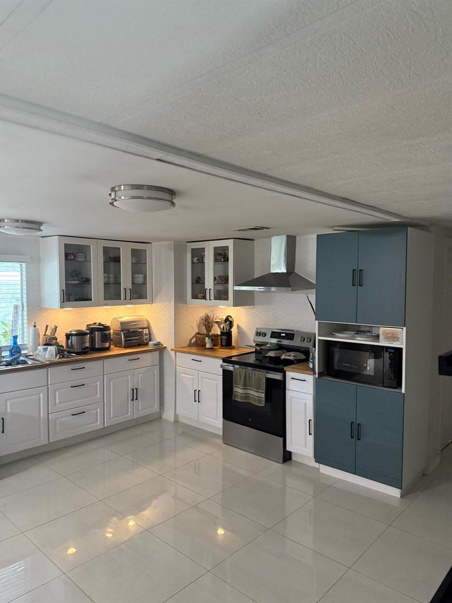 Spectacular 4 Bed / 2 Bath Mobile Home - All-Ages Community in Palm Beach Gardens Take advantage of this Opportunity,  won't last long!  This 4-bedroom, 2-bathroom with spacious lay out, Mater bathroom with a Jacuzzi , walking closet, just renovated kitchen and floors,  located in a very desirable area.  Huge back yard to enjoy you family. Community counts with club house, Fitness room, resort style pool, Jacuzzi, basketball court, boat and RV storage availability. Prime location, walking distance to shopping, restaurants, supermarkets. beaches, schools, Etc. Easy to show.
