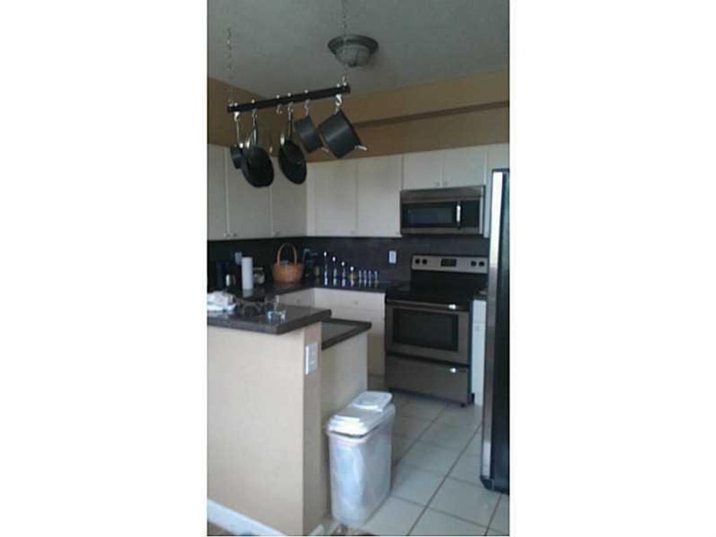 Photo of 130 Jacaranda Country Club Drive, Plantation, FL 33324 (MLS # F10549021)