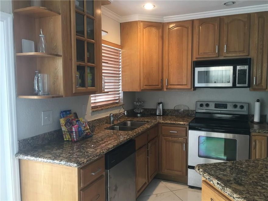POOL HOME!! THIS CHARMING 3/2 HAS A 1 CAR GARAGE WITH A CIRCULAR DRIVEWAY. TILE THRUOUT LIVING AREAS. KITCHEN HAS GRANITE COUNTERS AND STAINLESS APPLIANCES. KITCHEN ISLAND IS MOVABLE AND HAS A MATCHING GRANITE COUNTER. MASTER BEDROOM HAS A LARGE WALK-IN CLOSET.  BOTH BATHROOMS UPDATED. 3RD BEDROOM IS USED AS A DEN, BUT SELLER WILL CONVERT IT BACK, IF REQUESTED. FRENCH DOORS FROM KITCHEN OPEN ONTO COVERED PATIO OVERLOOKING THE POOL. CHILD GATE SURROUNDS THE POOL. LARGE FENCED YARD.