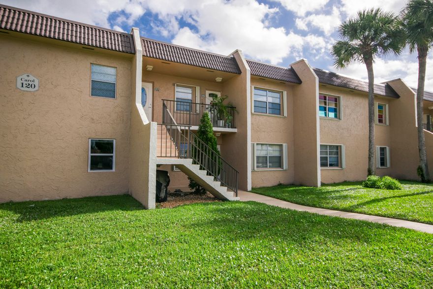 Welcome home to this beautifully updated, move-in ready residence in the highly desirable Golden Lakes Village 55+ community, offering the ideal blend of modern upgrades, comfort, and turnkey convenience.  Thoughtfully maintained, this home features tile flooring throughout and a series of tasteful improvements that truly set it apart. The meticulously redesigned kitchen has been fully opened and renovated, showcasing premium KitchenAid appliances, custom cabinetry extending to the ceiling, and elegant granite countertops with a matching backsplash—perfect for both everyday living and entertaining.  Impact-rated front windows and a new impact front door installed in 2023. Major systems have already been addressed with a brand-new AC and water heater installed in 2025 The primary bathroom was renovated around 2016 and remains in excellent condition.  Furniture is negotiable, making this an excellent opportunity for a fully or partially furnished, turnkey purchase.  Ideally located, Golden Lakes Village offers a convenient lifestyle close to major highways, shopping, dining, and downtown West Palm Beach, all within a well-established 55+ community known for its amenities and accessibility.