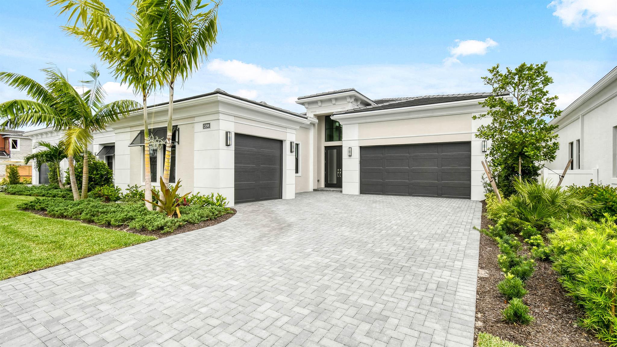 **New Construction - Move In Ready** This brand new Michaelangelo floorplan is situated on an interior waterfront homesite within Artistry Palm Beach. This home offers 3 bedroom suites, each with their own bathroom, an additional half bathroom and a 2 car garage. This Michaelangelo also includes gas cooking in the kitchen, 2nd tier upper cabinets, quartz backsplash, waterfall quartz kitchen island and under cabinet LED lighting. The house has an expanded owners walk in closet, double doors added to the den, and a gas connection for a future pool heater as well as gas, electric and water connection for an outdoor summer kitchen. One of the last opportunities for new construction in the heart of Palm Beach Gardens, the community of Artistry Palm Beach offers a 24/7 manned-gated entry and