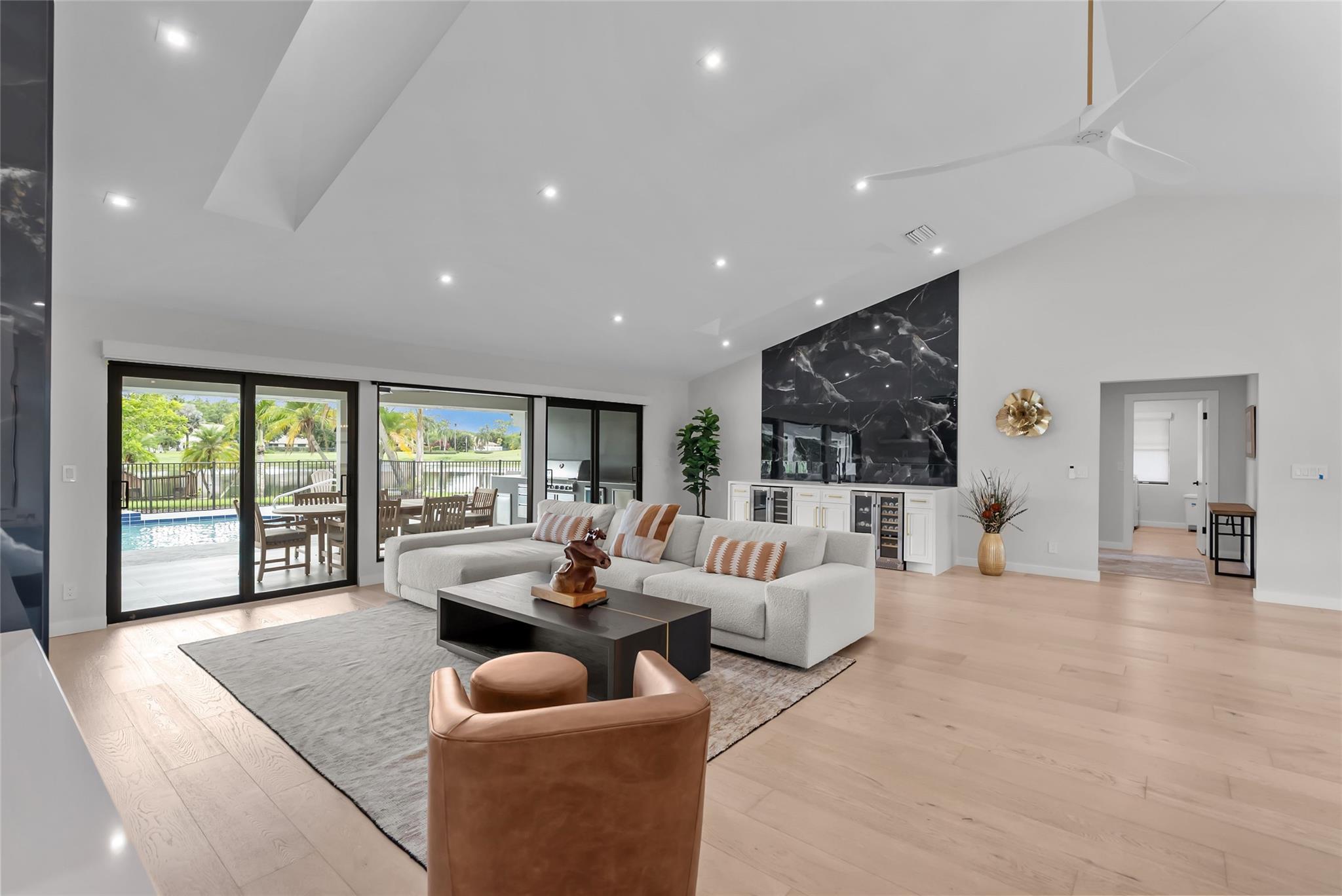 Discover a rare lakefront gem in this fully remodeled 4-bedroom, 3.5-bath home with new high-end finishes throughout. Located in the prestigious Bay Hill Estates, an exclusive 18-hole golf community with no membership required. Enjoy a chef’s kitchen with premium finishes, custom wall built-ins, and a spacious living room featuring a fireplace and wet bar. The master suite offers lake views and access to the community’s only private fishing dock. Step outside to an outdoor retreat with sunny southern exposure and a full summer kitchen, heated pool, and hot tub. A custom garage, EV charger, 24-hour security, low HOA, and a brand-new 2024 roof. Conveniently located near PGA and shopping, this property is move-in ready offering the ultimate Florida lifestyle without the need for renovations.