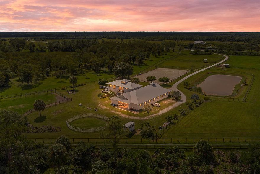 Set on 21.59 acres in the exclusive community of Trailside, this property combines established equine facilities with the opportunity to create a true luxury estate. This property's centerpiece is a nearly 5,000 sq ft CBS barn with 11 stalls, tack & feed rooms, and a guest house, all built in 2019 with hurricane-rated construction, rebar-reinforced walls, and modern engineering - providing a safe, secure living and equestrian environment. The barn also offers flexibility to convert part of the space into a custom residence if desired. A designated homesite is ready for a main residence, with underground power already installed, offering the chance to build a luxury estate. This private, secluded property is fully fenced & cross-fenced with multiple pastures & paddocks. Full-pro