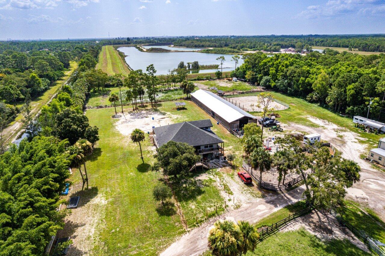 NO OTHER PROPERTY LIKE THIS - NO HOA 15.25 ACRE horse farm with 24 stall (12x12 and 16x12) center isle barn with room to build another barn! WANT A COVERED ARENA? NO PROBLEM! Only 1/3 of the property has been developed leaving ample space to create the horse farm of your dreams! 7,200 sqft out building for hay and equipment storage and workshop area. Climate controlled shed for feed and/or tack. The 2,588 sqft home has incredible exposed beams and wrap around porch giving it a rustic mountain feel on raised foundation, overlooking the entire property. Main level offers 3 bedrooms, 2 newly updated bathrooms, open kitchen to be updated with new cabinets and countertops, formal dining room, living room and newly updated laundry room, loft offers bedroom and full bath. Perimeter fenced with