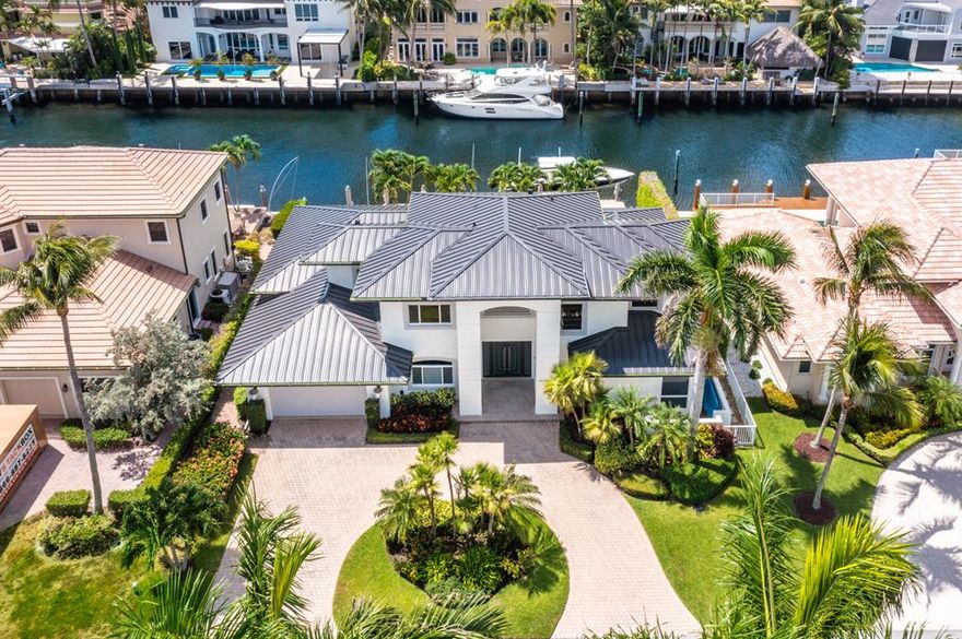 Gorgeous waterfront views from this newly renovated & spacious 4 bedroom home on a deep, wide canal with a newly redone dock for approximately 80 ft boat & a 16k boat lift. Beautiful sun filled patio and grounds with a modernized full tile automatic pool and spa. High ceilings throughout. Luxurious state of the art kitchen and baths. Downstairs master bedroom has spacious closets and great views. The master bath has an infrared sauna, steam shower and stand alone tub. Large porcelain floors downstairs and new wood floors upstairs. All hurricane impact windows, new roof, electric shades, full house generator, security system, 3 zone Air Conditioning and central vacuum. Spectacular home. Move right in and enjoy the tropical lifestyle!