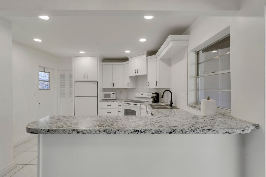 Welcome home to this beautifully updated 2-bedroom, 2-bath, 55+ condo - located on the second floor, in the desirable Greenway Village community. Enjoy peace of mind with the roof updated in 2023, along with a newer water heater. This light and bright unit features tile flooring throughout the main living areas, a spacious white kitchen with white appliances, and neutral carpet in both bedrooms, for added comfort.  The bathrooms have been refreshed with new cabinetry, and the condo offers two separate entrances for added convenience. Step out onto the screened balcony--perfect for relaxing and enjoying the Florida breeze.  Assigned parking space is front row for convenience. Greenway Village offers fantastic amenities, including a pool, its own dog park, and is conveniently located directly across the street from Commons Park. Cable, Wi-Fi, water, and building insurance are included, adding even more value. The community is close to many shops, restaurants and just a 20 minute drive to the beach.  Don't miss this opportunity, schedule your showing today!