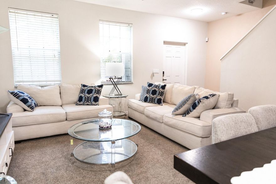 Spacious 2-story townhome in desirable East Port St. Lucie community with shaded walking paths, lakes, pool, and park. Downstairs features a large carpeted living area, half bath, and tiled eat-in galley kitchen. Upstairs offers 2 master suites, each with private bath and walk-in closet. Washer/dryer and linen closet on the landing. One-car attached garage, one-car driveway, and street parking available. Conveniently located near hospital, grocery stores, and restaurants. Well-maintained and move-in ready!