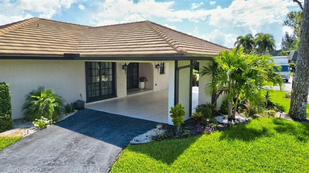 Photo of 429 Pine Villa Drive, Atlantis, FL 33462 (MLS # B26029592)