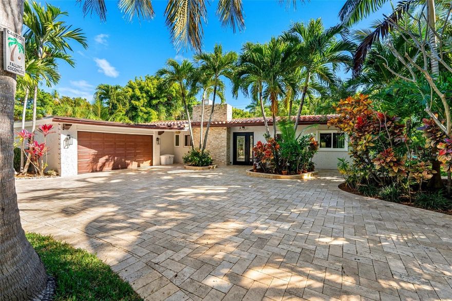 Unparalleled privacy & resort-style living await in one of Fort Lauderdale’s most exclusive neighborhoods! Enjoy the deeded private beach club & marina just steps away, plus walk to all the amenities of Ft. Lauderdale Beach! Gated privacy wall & fence surround this serene tropical oasis w/ heated saltwater pool & spa, expansive paved patio & Florida room w/ wet bar & retractable screens — perfect for entertaining. Set on a 16,180 sq. ft. oversized lot, this 2,550+/- total sq. ft. open-concept home boasts cathedral ceilings, Saturnia tile floors & a beautifully renovated kitchen. Abundant natural light, wood burning fireplace & custom built-ins add to the ambience. Add’l upgrades: new roof (2025), professional landscaping, travertine paved circular driveway & all-impact windows & doors.