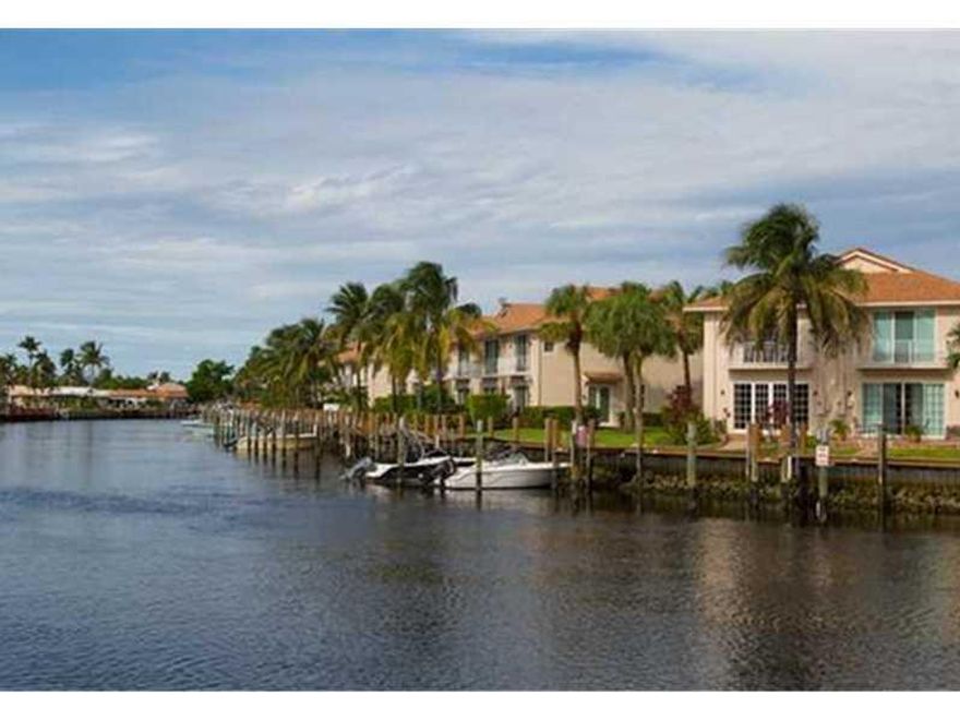 Motivated Seller - CALLING ALL BOATERS!  2 story waterfront townhome w/ garage, tropical garden patio & deeded dock.  This newer home is beautifully well maintained in a quaint waterfront gated complex* in E Pompano.  Nice tiled 1st floor, impact windows,  10' ceilings, open concept kitchen w/ granite, 1/2 bath & spacious liv area. 2nd floor features wet bar, NEW washer/dryer, jacuzzi tub & walk in closet. *Heated pool, pet friendly, reserves, low maint includes dock elect/h20*  Quick closing OK!