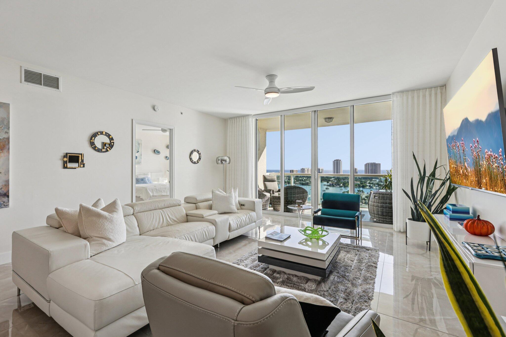 Beautiful sunrises and amazing intracoastal views from this 23rd floor Ocean Tower 2 bd plus Den/bdm. 2 bath designer home. Custom features: newer SS appliances, newer AC, new light fixtures, remodeled showers with frameless doors and hardware, new toilets, new 24 x 48 porcelain floors throughout, custom closets, and den converts into a bdrm with a bifold for privacy, and high-end furnishings. Amenities are endless: tennis courts,4 pickleball courts, bocce ball, fitness center, large heated pool, 4 grills, card rm poker rm, billiard rm sauna, steam rm, and an intracoastal gazebo, valet, 24 hr guard and much more! Public across the street and a full-service marina adjacent to the property and a 10 min. walk to the beach, PBI airport 20 mins. away. Best hidden gem in Palm Beach County!