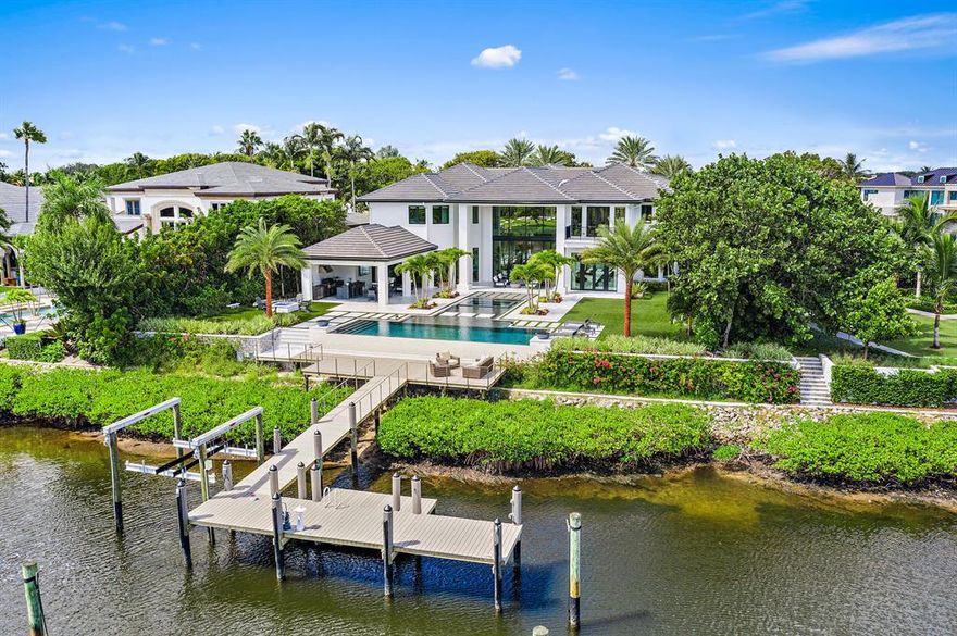Modern sleek design with dramatic open spaces, soaring ceilings and water views from almost every room. This completely renovated home located in the prestigious Admirals Cove with 110 feet water frontage that can accommodate a 80 foot boat. Resort styled back yard with an expansive covered porch, full summer kitchen, Euro edge infinity pool & spa, fire pit, expanded dock. The home boasts 10,235 square feet under air with 5 en suite bedrooms, Hurricane Impact windows and doors, 2 master suites on the first floor with custom walk-in closets. Gourmet chef's kitchen custom cabinetry and top-of-the-line appliances including  Gas Wolf stove, double oven, Subzero refrigerator, and oversized pantry.  See supplemental...