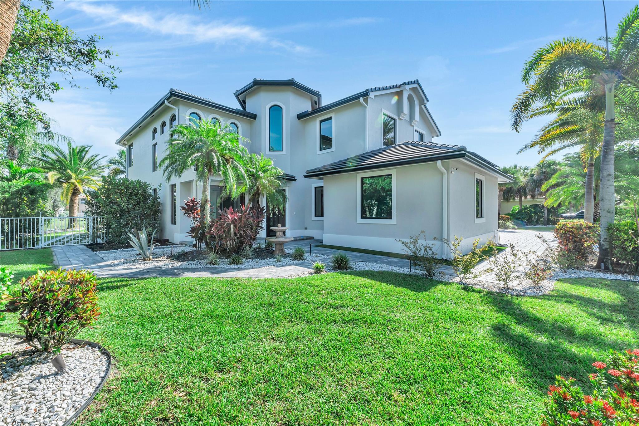 Your tropical oasis awaits at The Isles at Wellington on an oversized water lot. 4/5+ loft + 3-car garage, Tesla roof solar panels with 3 battery backups. Brand new roof & impact windows. Remodeled kitchen, first floor bathrooms, primary bathroom & new window treatments. Backyard perfect for outdoor entertaining with a state of the art salt pool with a full automative system, synthetic turf, playground, built-in summer kitchen, gazebo, outdoor shower, 2,500+sq ft of porcelain tile decking. New carpet installed at stairs/upstairs. Complete custom garage with interlocking floor tiles, cabinets, work table, utility sink, refrigerator, water softener treatment center and pressure washing system.