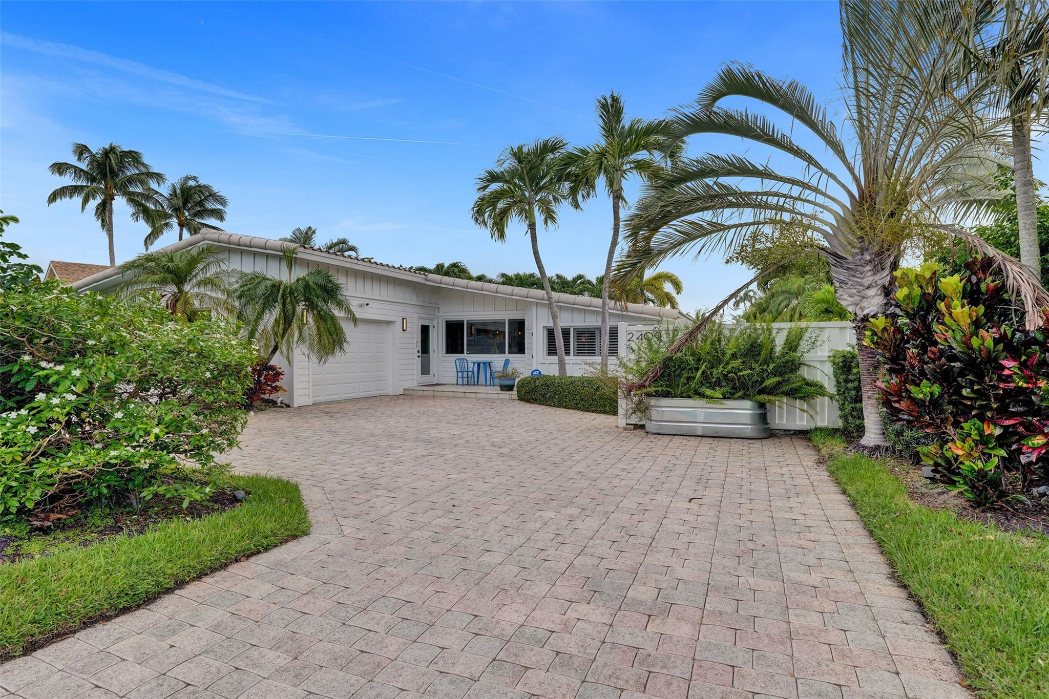NEW PRICE ADJUSTMENT- JUNE 2025, A must-see home!! A Tranquil Masterpiece- Step inside and feel a profound sense of calm. This luxurious, move-in ready East Wilton Manors waterfront 3/3 home has been exquisitely renovated, showcasing coastal elegance in soothing tones. Designed for daily living and entertaining, the expansive open kitchen features professional-grade appliances, quartz countertops, and a wine chiller. Folding glass doors in the living room create seamless indoor-outdoor living, leading to a backyard with a large L-shaped heated saltwater pool, a 70' dock, and a 5K lb boat lift. Every detail has been thoughtfully considered, making this home a peaceful, luxurious retreat.
