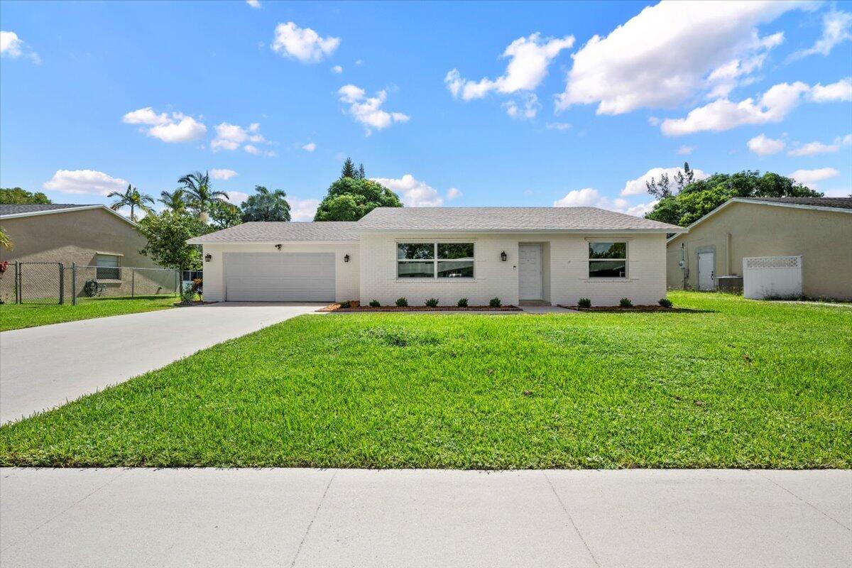 Nestled in the heart of Royal Palm Beach, this well-maintained CBS home offers a 40 ft driveway, 1,604 sq ft under air (with a flexible media room/4th bedroom) and a total of 2,462 sq ft including laundry and storage. Enjoy a spacious layout with formal living and family rooms, updated baths,ceramic tile floors in main living areas, crown moulding, and no popcorn ceilings. The kitchen features granite counters and backsplash, wood soft-close cabinets, and Frigidaire appliances. Step outside to a fully fenced yard with mango trees and both covered and open patio spaces. enjoy private water views from the dock. Additional perks: 2024 roof,PGT impact windows and doors + shutters, and upgraded 3-ton AC (2015). No HOA, great location, and move-in ready!