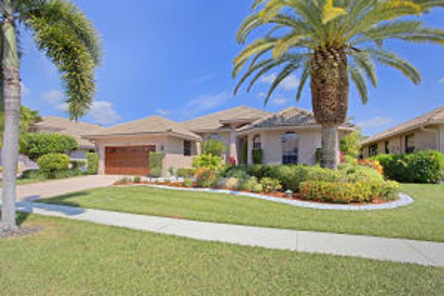 Simply spectacular custom pool home in La Corniche! Wide open floor plan features expanded room dimensions. The breathtaking, expansive living room and dining area are the focal point of this magnificent residence. Beautiful over-sized marble flooring and crown molding throughout living areas. Gorgeous updated kitchen features granite counters, double wall ovens and a tremendous amount of storage.Eat-in kitchen overlooks screened patio and pool with water fall feature. Summer kitchen is complete with mini refrigerator and new grill. Master suite boasts huge walk in closets and his and her bathrooms. Den originally designed as formal dining room. Easily converted back or used as 4th bedroom. Recently renovated  community entrance, landscaping & clubhouse makes this non-mandatory country club community highly desirable!