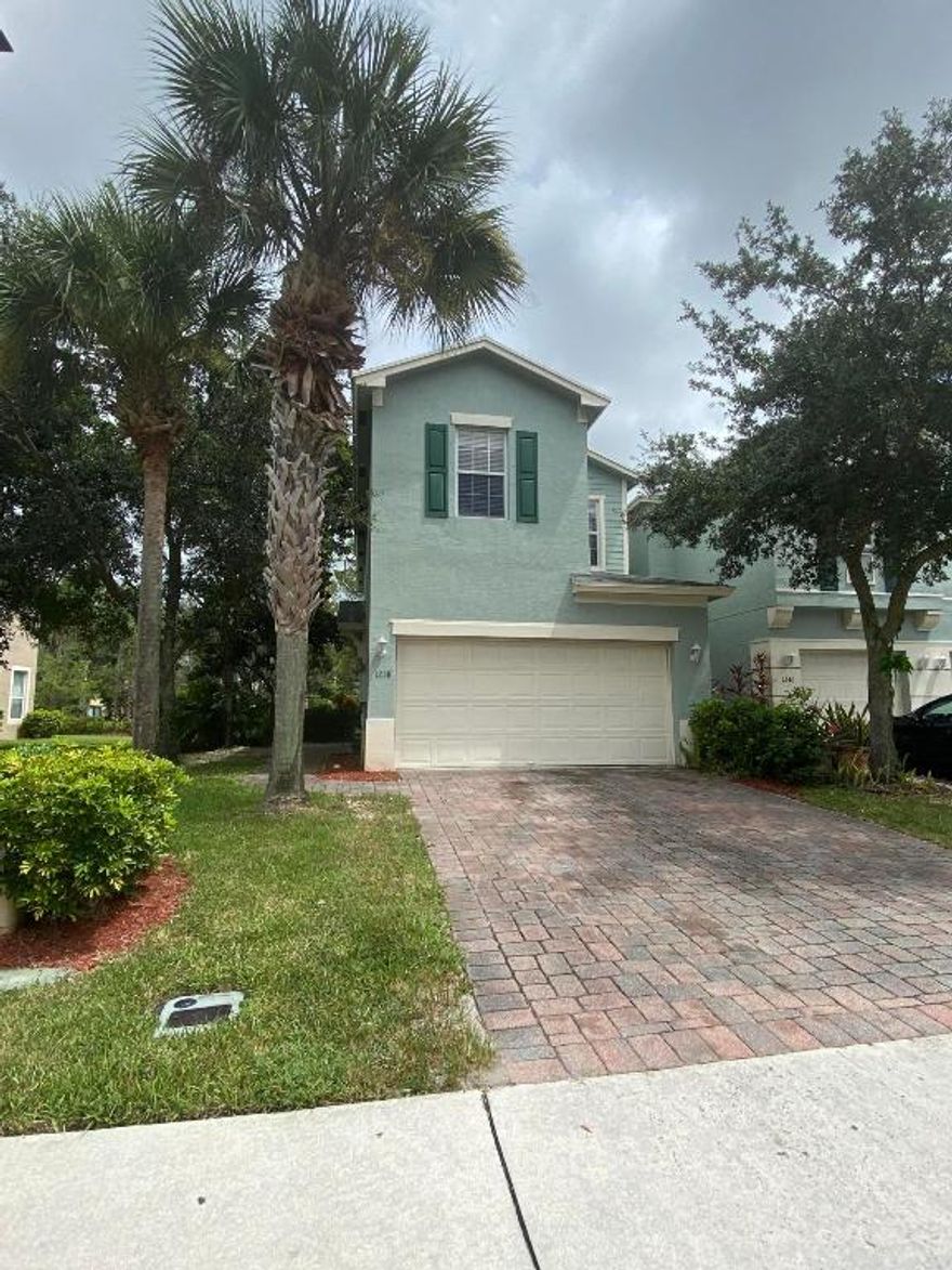 Come see this CORNER townhouse located in the desirable Victoria Woods. Upon entry there is ceramic tile and laminate wood floors throughout the rest of home. Kitchen features shaker cabinets and stainless steel appliances. Half bathroom is located downstairs.  3 bedrooms with closets in each room and 2 full bathrooms are located upstairs. Owner's suite features tray ceiling, over sized closet and en suite bath with double-sink vanity. Two car garage with driveway capable of holding four(4) cars. Community amenities include tennis courts, basketball courts, racquetball courts, a playground, baseball field, cabanas and swimming pool. Property is centrally located for minutes travel to beaches, hospitals, PBI, downtown West Palm Beach, City Place, Wellington Green Mall and Palm Beach Outlets