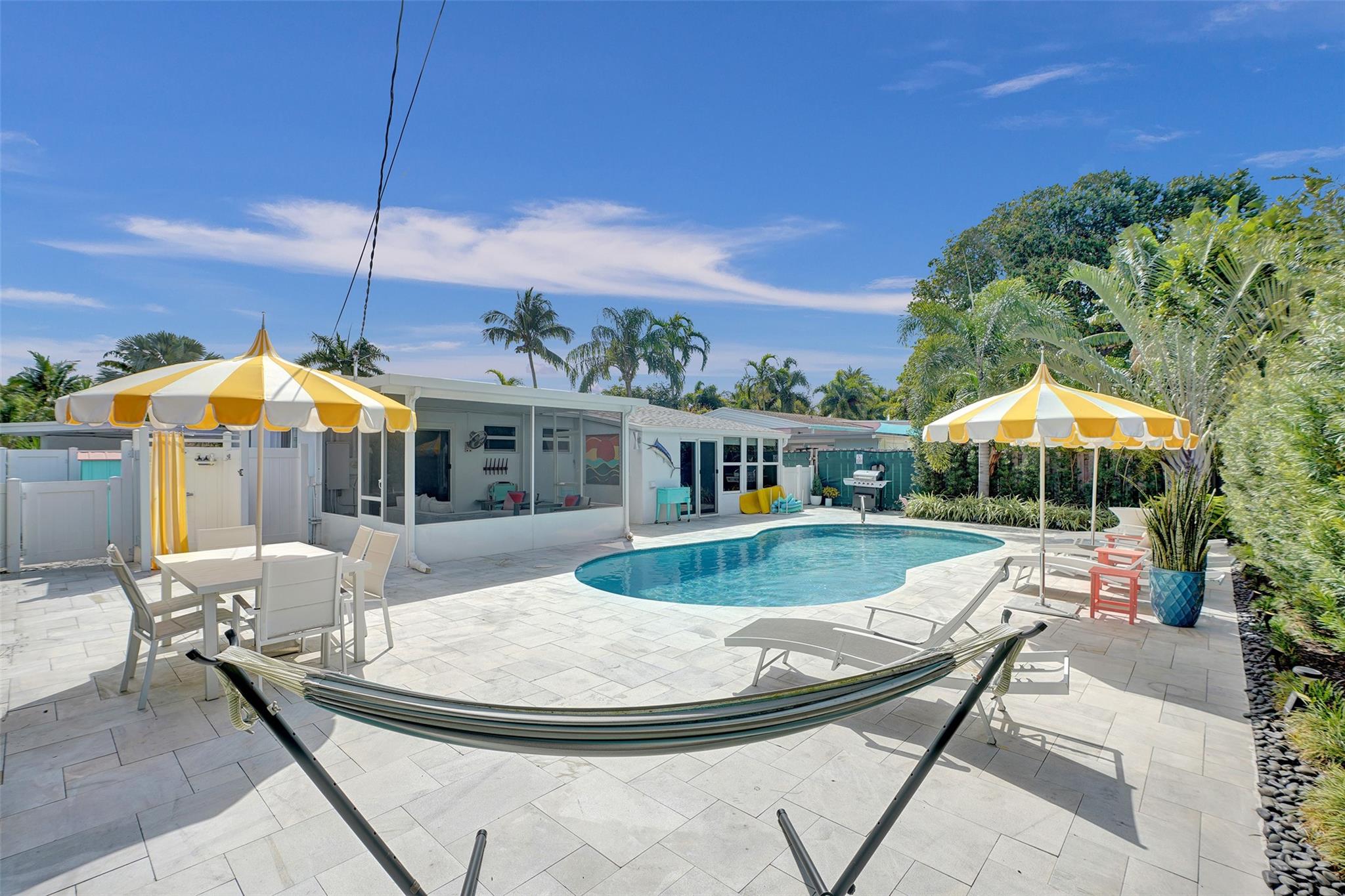 WELCOME TO POOLSIDE REFLECTIONS - A COMPLETELY RENOVATED 3 BEDROOM 2 BATH HOME WITH A PALM SPRINGS VIBE ON A VERY QUIET STREET WALKING DISTANCE TO THE DRIVE. HOME FEATURES A MODERN OPEN KITCHEN WITH ISLAND AND UPDATED APPLIANCES. BOTH BATHROOMS ARE RENOVATED AND FLOORING IS RESTORED TERRAZZO. ALL IMPACT WINDOWS AND DOORS AND NEWER ROOF (2022). BACKYARD IS A TROPICAL OASIS COMPLETE WITH HEATED POOL, OUTDOOR SHOWER, COVERED SCREENED LANAI AND LOTS OF DECK SPACE FOR ENTERTAINING.