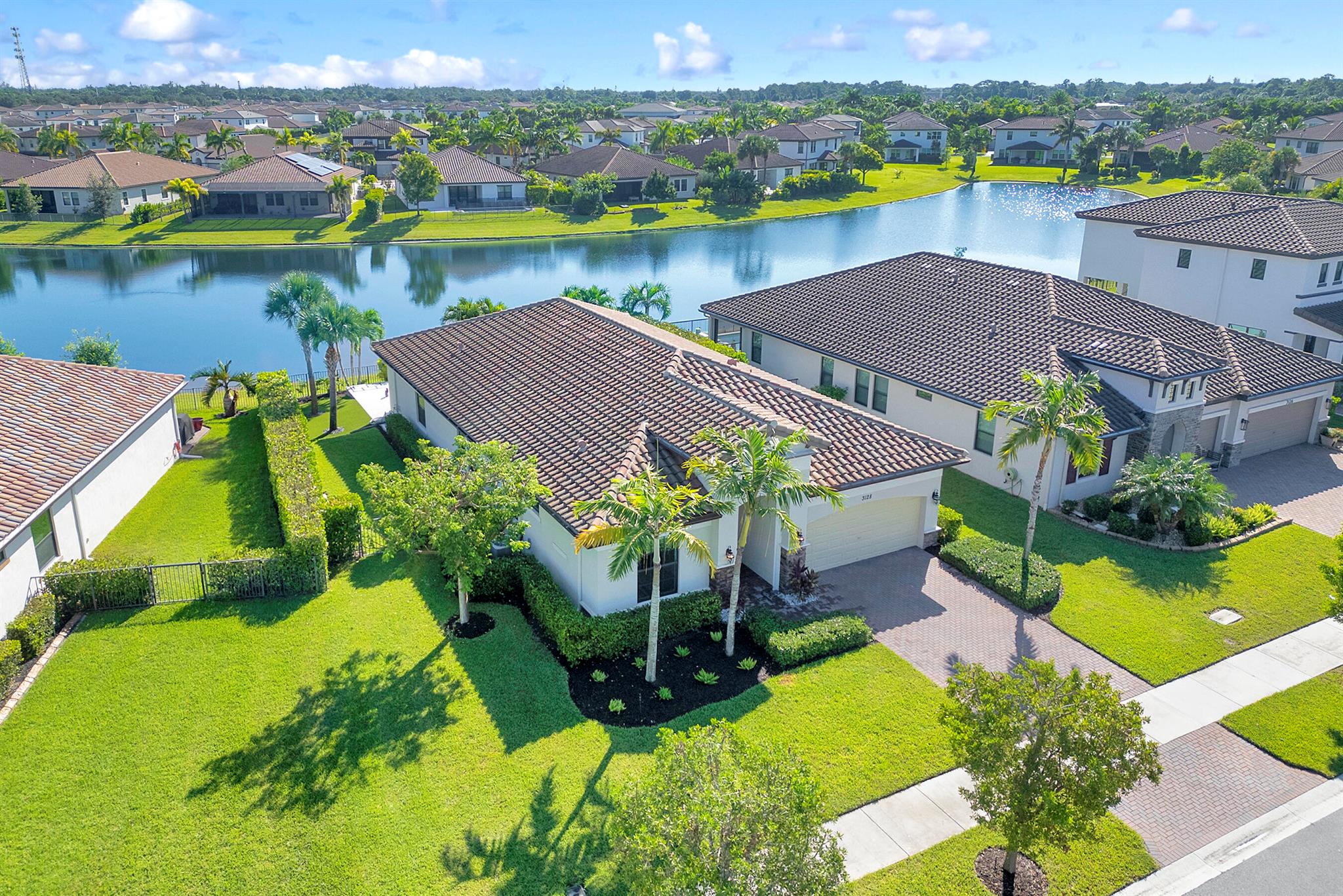 Welcome to your dream home! This one-story lakefront residence, built in 2020 on a premium lot within a gated community offering resort-style amenities, blends elegance and comfort. Featuring tray ceilings, designer lighting, and tile & wood flooring throughout, the open layout highlights a spacious kitchen with upgraded appliances and a three-panel slider leading to a backyard oasis with a pool, spa, and marble decking overlooking the lake. Additional features include hurricane-impact windows, electric blackout shades, a den with built-in cabinets, and a primary suite with a custom closet fit for a princess. Complete with backyard with turf backyard, two-car garage with epoxy flooring and shelving, this home offers the perfect mix of sophistication and convenience.