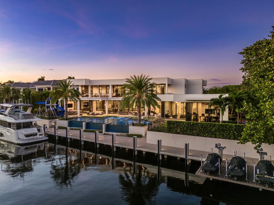 Immerse yourself in unparalleled luxury with this extraordinary furnished waterfront estate by SRD Building Corp. Spanning over 11,400 square feet of refined living space, this six-bedroom, eight full and two half-bathroom home is on 166 feet of deep-water frontage, offering a yacht-ready dock and southern exposure. A stunning waterfall wall fountain sets the tone as you enter the dual-entrance motor court driveway. The first-floor owner's wing is a private sanctuary with His & Her spa-like bathrooms, a dedicated wellness/gym with a full spa bath and steam shower, and a tranquil sitting room. For car enthusiasts, showroom-style garages with glass walls provide a striking display for your collection enjoyed from the private study. Designed by P&H Interiors for grand-scale entertaining, the sleek clubroom features a bar, billiards area, and a glass-enclosed wine room. The chef's kitchen, outfitted with premium appliances and a spacious eat-in dining area, ensures a culinary experience to match the home's sophistication.

Outdoors, the resort-grade backyard is an expansive private oasis boasting a pool, spa, turf yards, and a tremendous covered terrace, perfectly oriented to capture the sun-soaked southern exposure. Cutting-edge Crestron smart-home technology and advanced security systems ensure effortless living at the highest level of convenience and safety. This exceptional residence is a rare opportunity to own a true masterpiece of modern luxury.