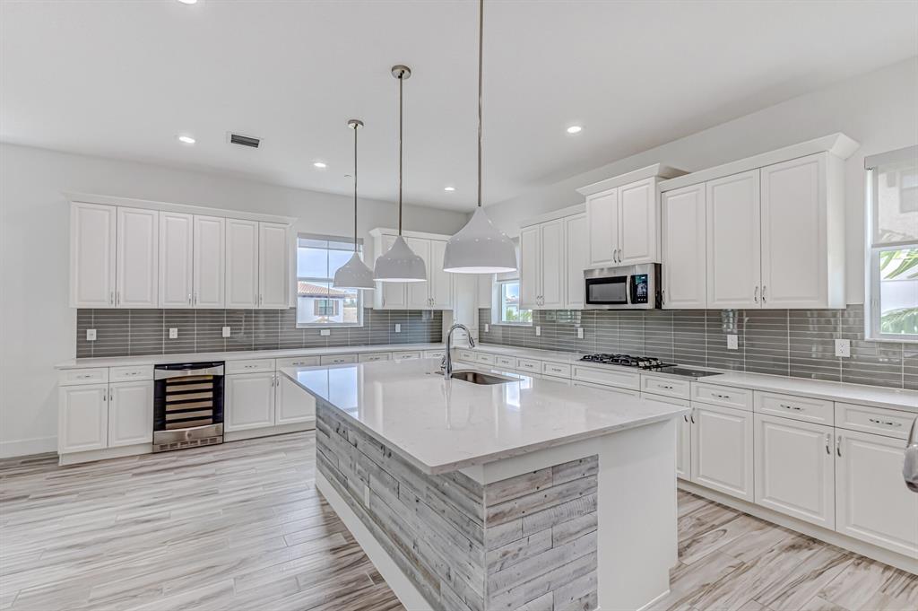 PRICE REDUCED! Experience luxury living in this exceptional 3 bedroom, 3.5 bath corner unit townhome in the highly sought-after Alton community. This Bristol model/Town A home boasts an unbeatable location, situated on a neighborhood green space and just steps away from Alton Town Center. As you step into this move-in ready property, you'll be greeted by an abundance of natural light streaming through on three sides of this corner unit. Enjoy the convenience and efficiency of natural gas throughout the home. The gourmet kitchen is sure to impress with its quartz countertops, wall oven, backsplash, center island with wood detail, wine fridge, and soft-close white cabinets providing ample storage. The generous master suite includes custom closet built-ins and a luxurious en-suite bathroom.