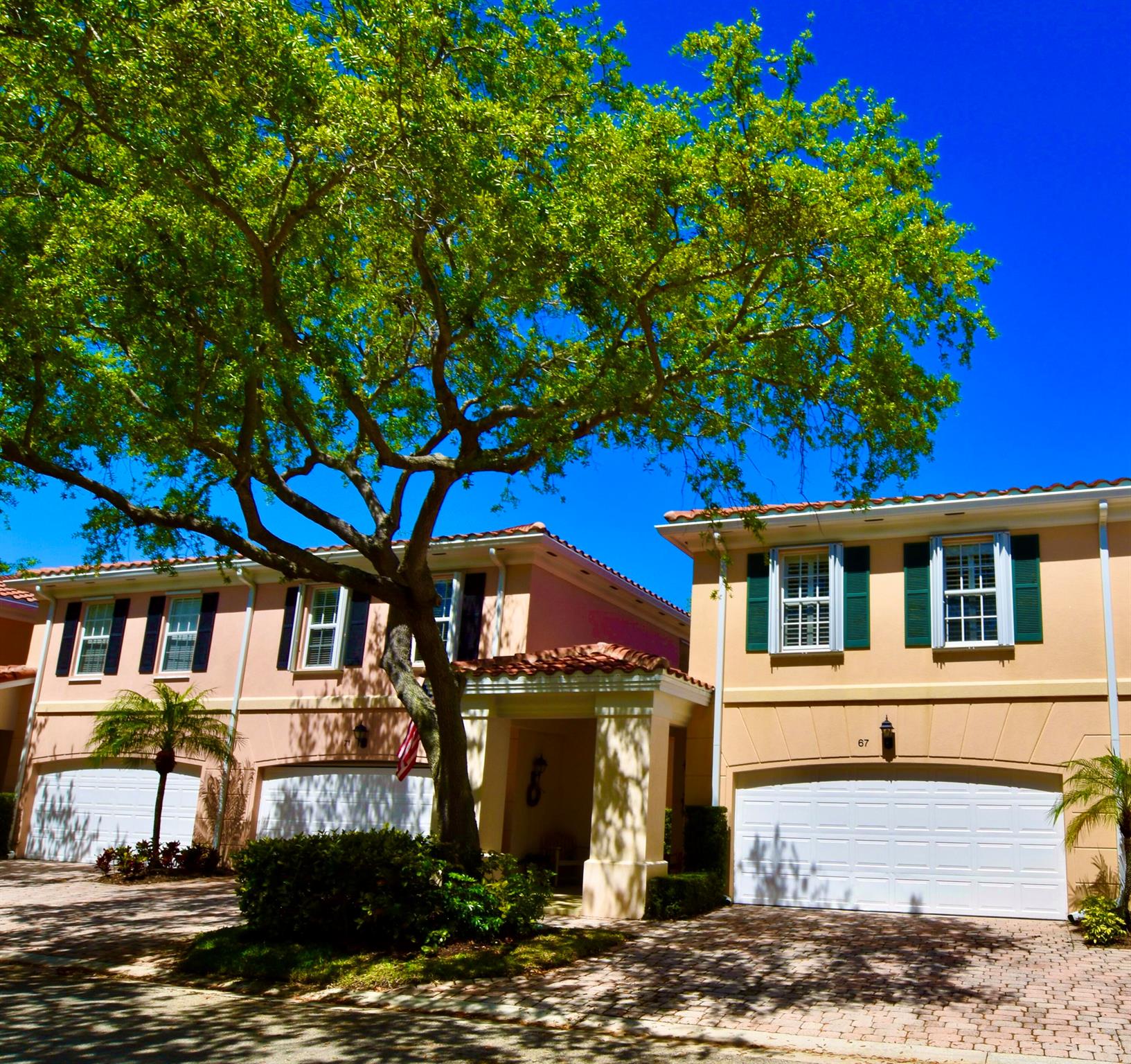 Divosta built, fully concrete constructed, 3BR, 2.5Bath Townhome in an oak lined, private, well managed community. Townhome situated on premium lot that backs to parking lot. Unit located 4 units from community pool. Interior features include hardwood flooring, new (never used) stainless steel refrigerator, microwave, dishwasher, garbage disposal, and kitchen faucet. Open floor plan downstairs. Upstairs- laundry, primary bedroom with ensuite primary bathroom and walk-in closet and plantation shutters. Screen and paved back patio and screen enclosed back porch w/ vinyl windows/ability to A/C the screed porch. Accordion hurricane shuttler, impact glass sliders and tile roof replaced 2023. A/C new 2023. Garage door opener replaced 2023. Zoned for A rated Jupiter Schools.Watch video
