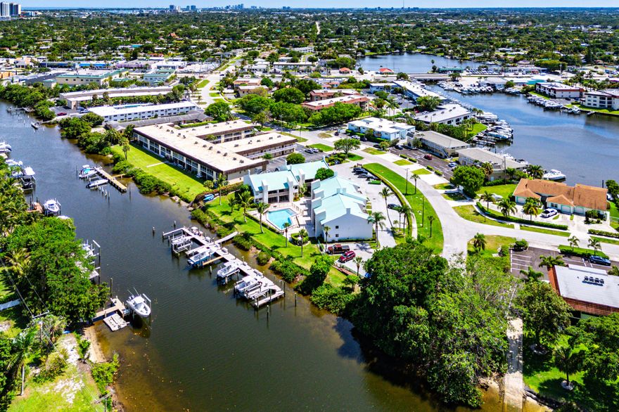 Newly remodeled 2/2 waterfront North Palm condo available on the Earman River. Impact windows + slider doors + front door with blinds, vinyl and tile throughout, remodeled bathrooms, knockdown ceilings, updated lighting, soft close cabinets and drawers, and quartz countertops. All appliances updated including black stainless kitchen appliances including in-range air fryer, new AC, tankless hot water heater, and washer & dryer.  Quiet community, screened in rear patio with river view and storage unit, front patio with room for a grill, plants and more, and additional view of river, paddleboard/kayak storage and stairwell for launch.