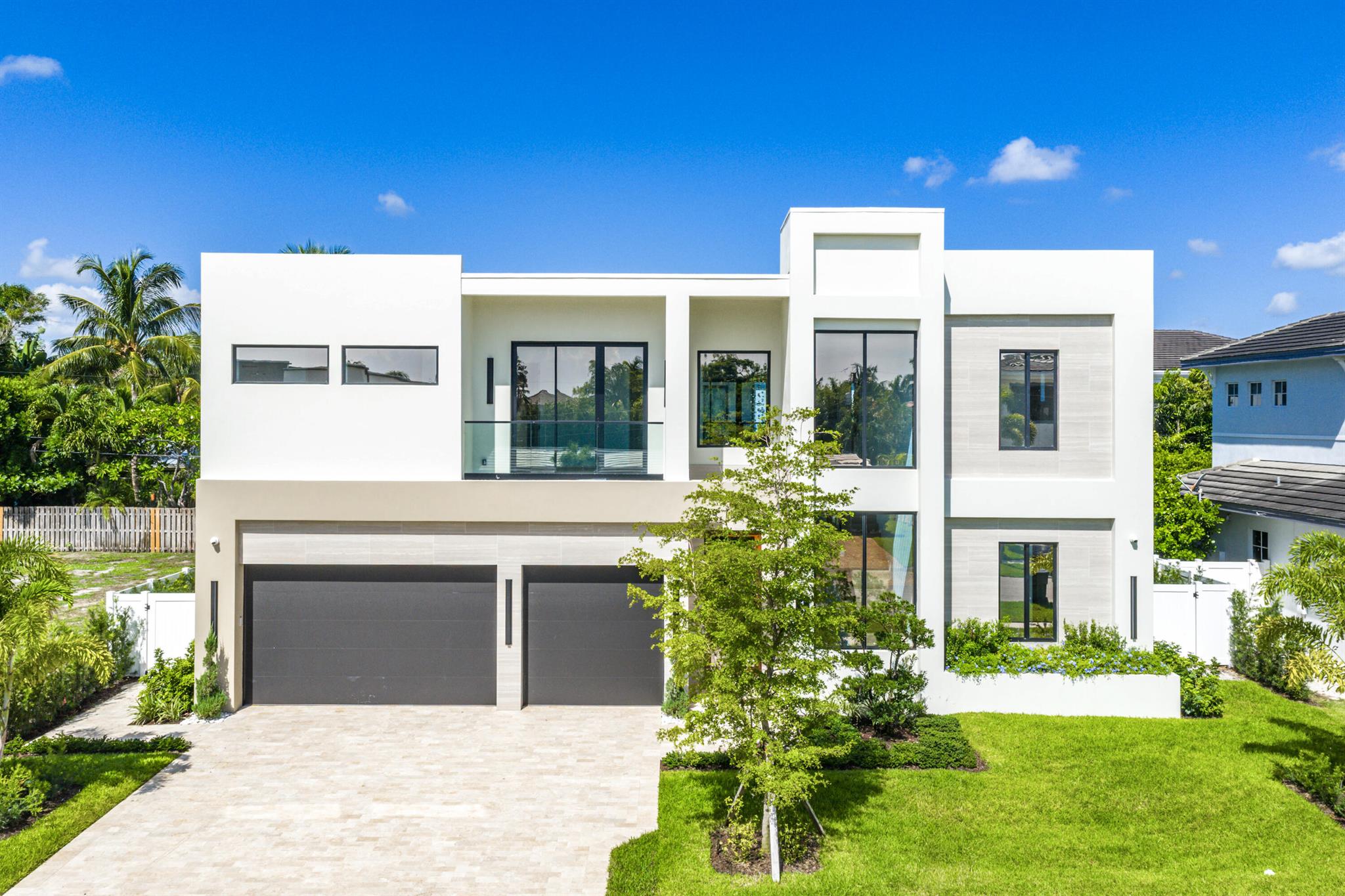 Welcome to 1031 NE 3rd Avenue, a newly constructed residence in the highly sought-after Boca Villas neighborhood, crafted by Skymar Custom Homes. This modern home sits on a 108' x 80' lot and offers a seamless blend of design, function, and location.The main level features an open-concept layout with a chef's kitchen highlighted by a 9.5' x 11' island, custom two-tone cabinetry, paneled Thermador column refrigerator and freezer, dual-gas and electric range, wall speed oven, built-in coffee maker, and walk-in pantry with secondary laundry. Living and dining areas flow naturally into the clubroom with a wet bar and designer finishes, along with a flexible office or guest suite. Smart home technology includes Control4 lighting and automation, Sonos sound system, security cameras