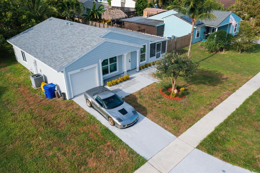 Welcome to your beautifully renovated, No Hoa,3 bedroom, 2 bathroom home, where modern and comfort meets style!! This stunning property features Brand New roof installed in 2025, providing peace of mind with premium insurance rates and enhanced hurricane resistance.

Step inside to appreciate the professionally installed Brand New flooring- Waterproof Rigid Core Luxury Plank with Moisture Barrier film - that flows seamlessly throughout the home, complemented by fresh , contemporary paint both inside and out. Both bathrooms have been completely renovated with state-of-the-art finishes that blend elegance and functionality.
Brand New hurricane-resistant windows and doors enhance safety and energy efficiency, while a brand new garage doors adds to the home's exceptional curb appeal . New lighting, ceiling fans, and stainless steel appliances contribute to the modern feel. The garage floor has been elegantly titled, creating additional living space perfect for a man cave, and is under air. The patio has been tiled, providing an inviting outdoor entertainment area.
No detail has been spared in creating a perfect family home. The property is conveniently located near the community lake for outdoor activities and relaxation. Close to Walmart, Gas Station, Wellington Mall, Airport, Top-rated schools, Lion County Safari, Calypso Water Park, BJ, and much more. 
Don't miss the opportunity to make this exceptionally renovated property your own. Grab this opportunity to enhance your family life with a place to call home. schedule your showing today! Vacant , Easy to show.