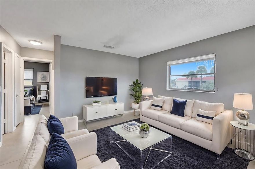 Beautifully remodeled condo east of I-95! This renovated 2-bedroom, 1-bath condo  unit is just minutes from the beach, restaurants, and shopping. Located on the top floor of a well-maintained community, this bright and airy unit offers abundant natural light, stainless steel appliances, granite countertops, and a custom backsplash.Your assigned parking spot is conveniently just steps from the apartment. Gated community - Amenities include a pool, tennis courts, BBQ areas, walking paths, and plenty of open green space - Gated community