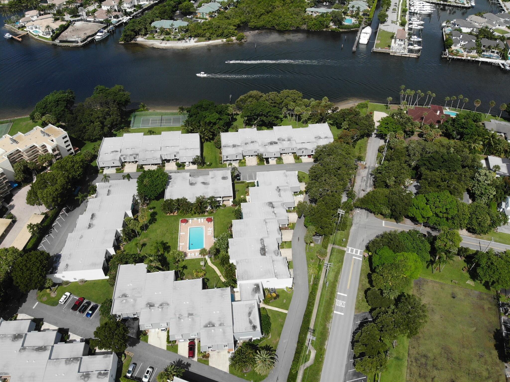 3 bedrooms 2 bathrooms in North Palm Beach in a unique 3 level split. This charming intracoastal community has a day dock. Imagine waking up to the gentle breeze and enjoying a cup of coffee on your private patio, overlooking the serene heated community pool. This meticulously maintained unit features plenty of space between bedrooms and is adorned with beautiful wood floors throughout and ample storage both indoors and out. California Closets are in 2 of the bedrooms offering a luxurious touch while maximizing space. Walk the sandy shoreline of the community at low tide- enjoy seeing manatees, starfish, and million dollar yachts go by. Bring your kayak and fishing pole! Play tennis/pickleball while having views of the pristine intracoastal. Walk to Stormhouse, Cod& Capers, Doris, & BWB!