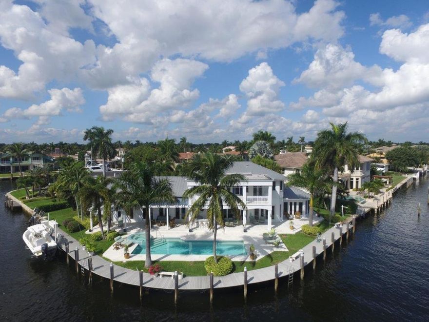 This fabulous ''Hampton's Style'' Home is situated on a remarkable 241+- Southeast Intracoastal Point Lot. Features include a tranquil front patio, Open Floorplan with Cherry Wood floors thruout, First Floor Master Suite with an adjacent Office, Open Kitchen to large Family Room and Breakfast Area, 3 Ensuite Bedrooms upstairs, large balcony overlooking the Intracoastal and 2 additional down. Large entertaining pool/ patio and dockage for a large yacht