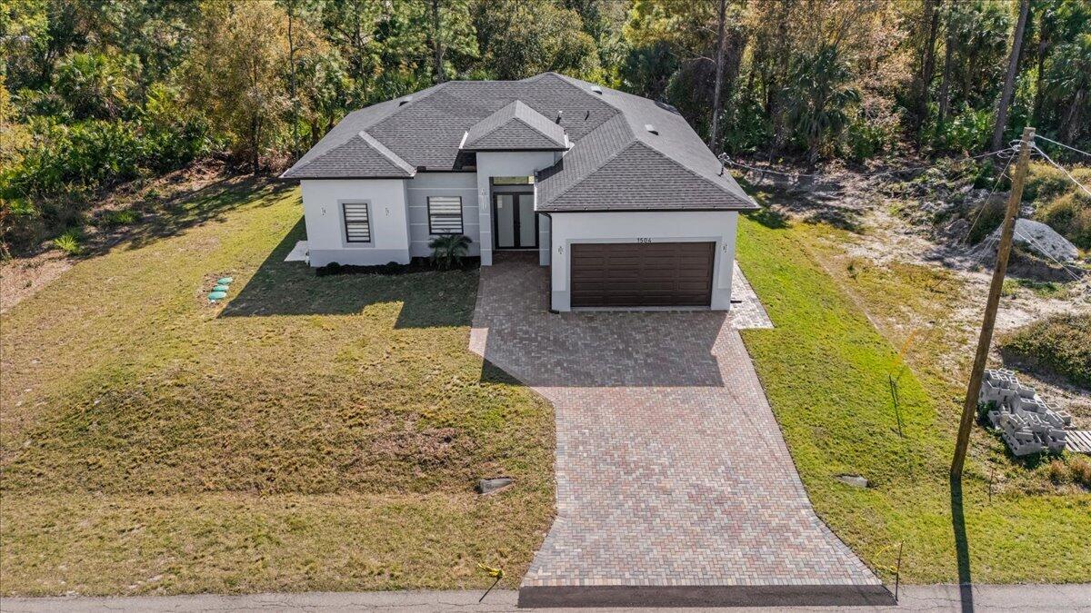 This stunning single-family home boasts 3 bedrooms, 2.5 bathrooms, and a 2-car garage, providing ample space for you and your family. The open concept living area is perfect for entertaining guests, with tile flooring, tray ceilings, and modern fixtures throughout. Impact windows and doors provide security and energy efficiency, while LED lighting and modern window blinds add a touch of elegance. The paver driveway adds curb appeal, and the large laundry room with a sink makes chores a breeze. Don't miss out on this opportunity to own a truly luxurious home in a desirable neighborhood. Make an appointment to see it today before it's gone!