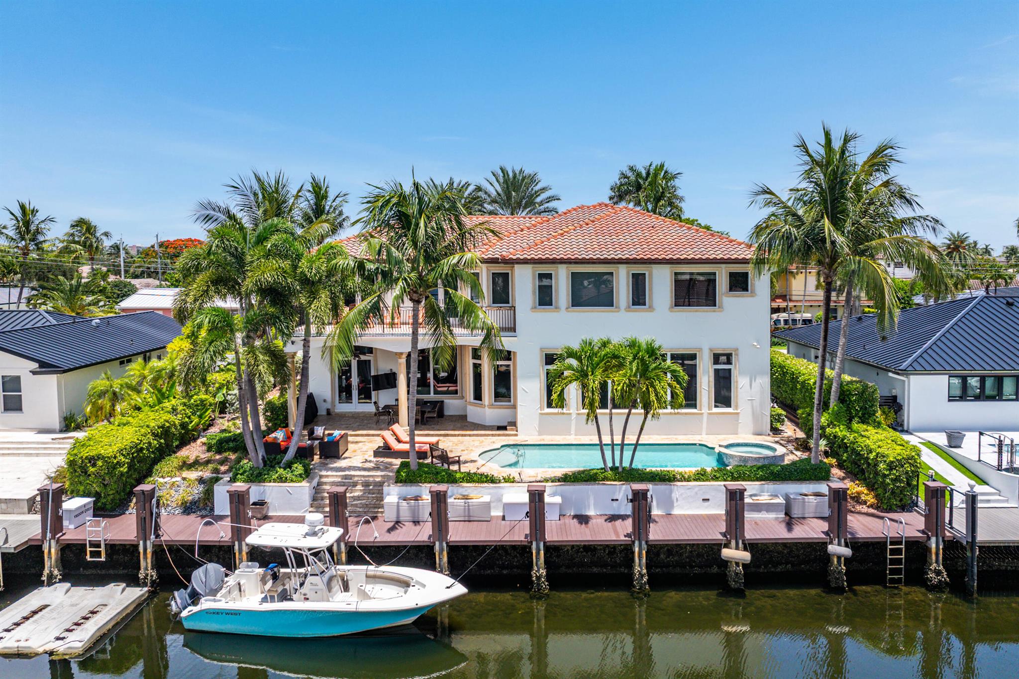 Welcome to your custom waterfront dream estate in prestigious Lighthouse Point!This meticulously maintained boater's paradise offers over 90 feet of deep-water dockage with no fixed bridges--just minutes to the Hillsboro or Boca Inlets. Designed for both luxury and comfort, this 7-bedroom, 4.5-bath home showcases beautiful architectural details, soaring tray ceilings, and an abundance of natural light throughout.Enjoy breathtaking sunsets (yes, those twilight photos are real!) from your expansive covered patio or relax by the pool, surrounded by elegant travertine pavers that also enhance the driveway and pool deck. The spacious primary suite features two oversized walk-in closets and direct access to the patio.