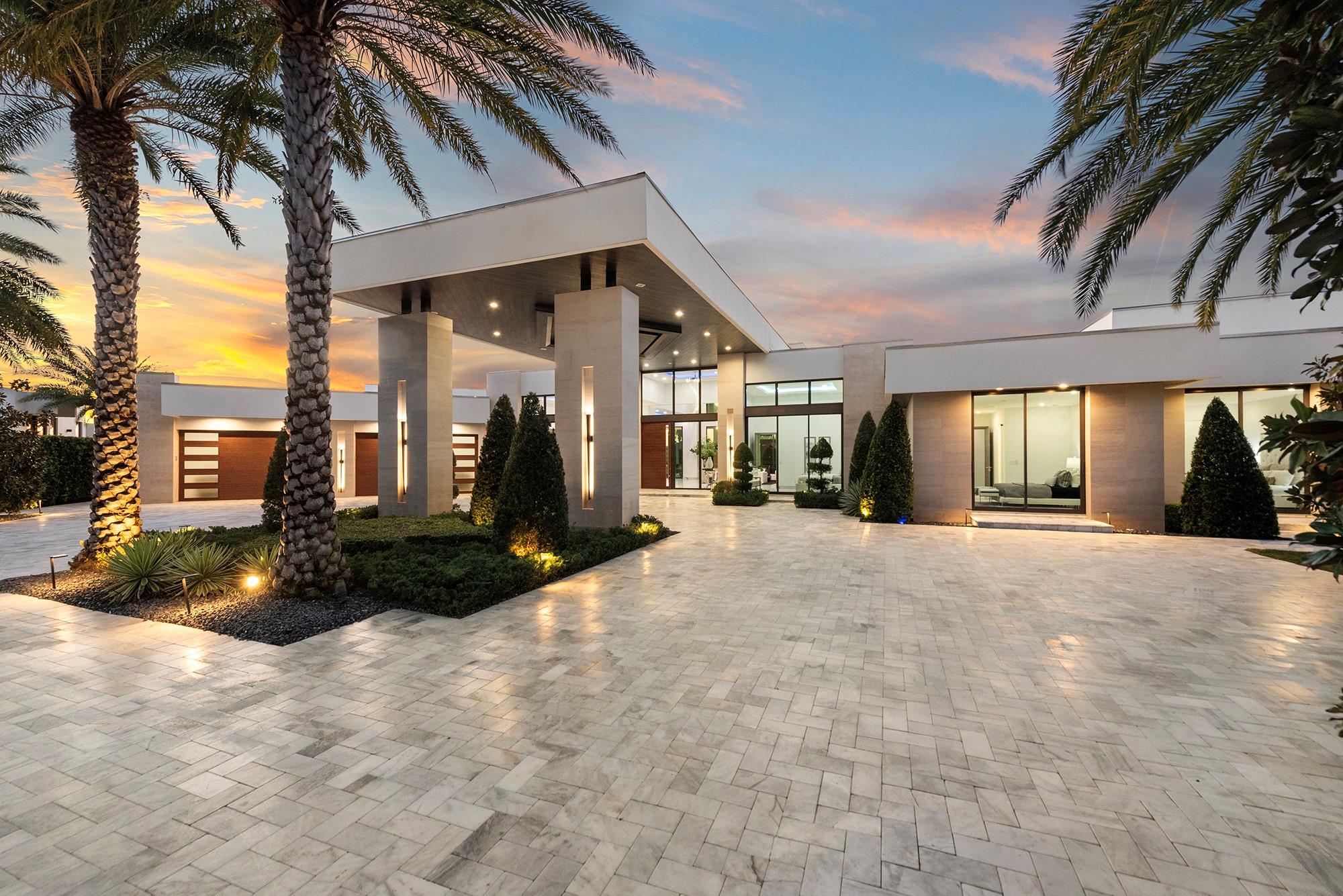 State-of-the-art custom estate, located within the prestigious Enclave at Coral Ridge Country Club in East Ft Lauderdale. This exclusive, guard-gated community of 32 homes with 24/7 manned security, ensuring ultimate seclusion & privacy while being a short distance to fine dining, shopping, 2 golf courses, the beach & private executive airport. Situated on an oversized corner 26,580SF lot, the home guarantees complete privacy and serenity. This one-of-a-kind single-story residence is a masterpiece of design with soaring ceilings & walls of glass provide expansive golf course views & multiple doorways blend indoor & outdoor living spaces. The grandeur of this custom-built home features 5BR, 6.5BA, office, media/club room, 5 Car A/C Garage with a glass wall will inspire the car enthusiasts.