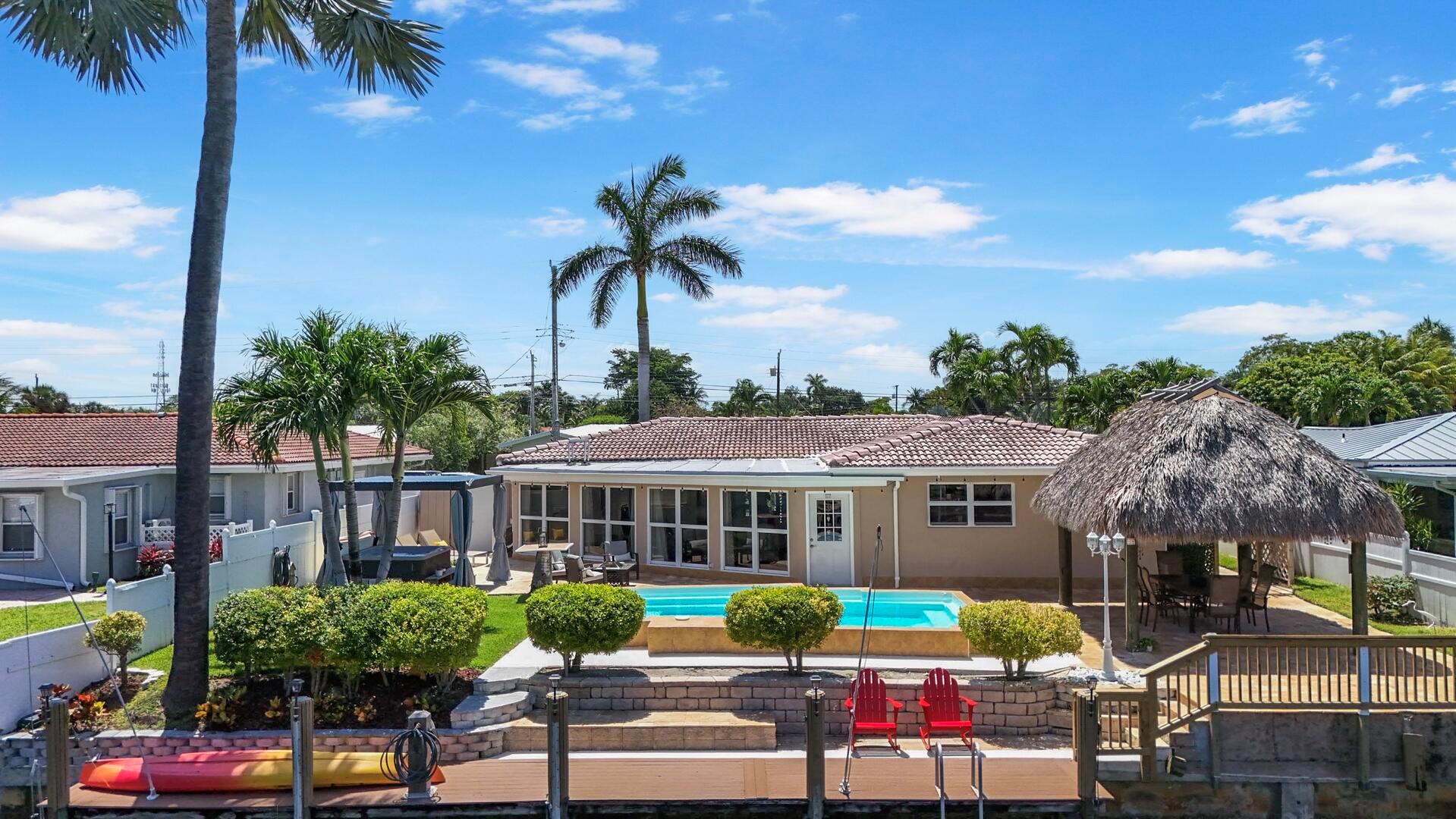Welcome to this beautifully updated two-bedroom, two-bath home, the perfect blend of luxury, comfort, and South Florida charm. Enjoy resort-style living with your own private swimming pool featuring multicolored lights, a relaxing hot tub, and a fire pit for unforgettable evenings. The outdoor space is ideal for entertaining, complete with a 70-foot dock equipped with electric and water hookups, boat whips, and a tiki hut--perfect for securing a 30-foot center console boat (tide-dependent). An outdoor shower with both hot and cold water adds to the convenience, and there's even a sauna for ultimate relaxation.