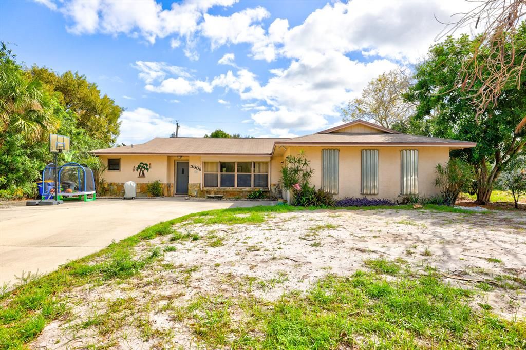 Photo of 5686 SE Matousek Street, Stuart, FL 34997 (MLS # R10866735)