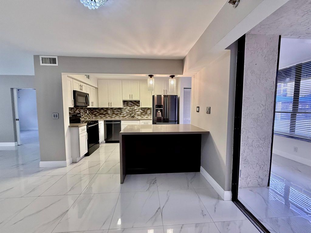 Photo of 7564 Regency Lake 102 Drive #102, Boca Raton, FL 33433 (MLS # R11072146)