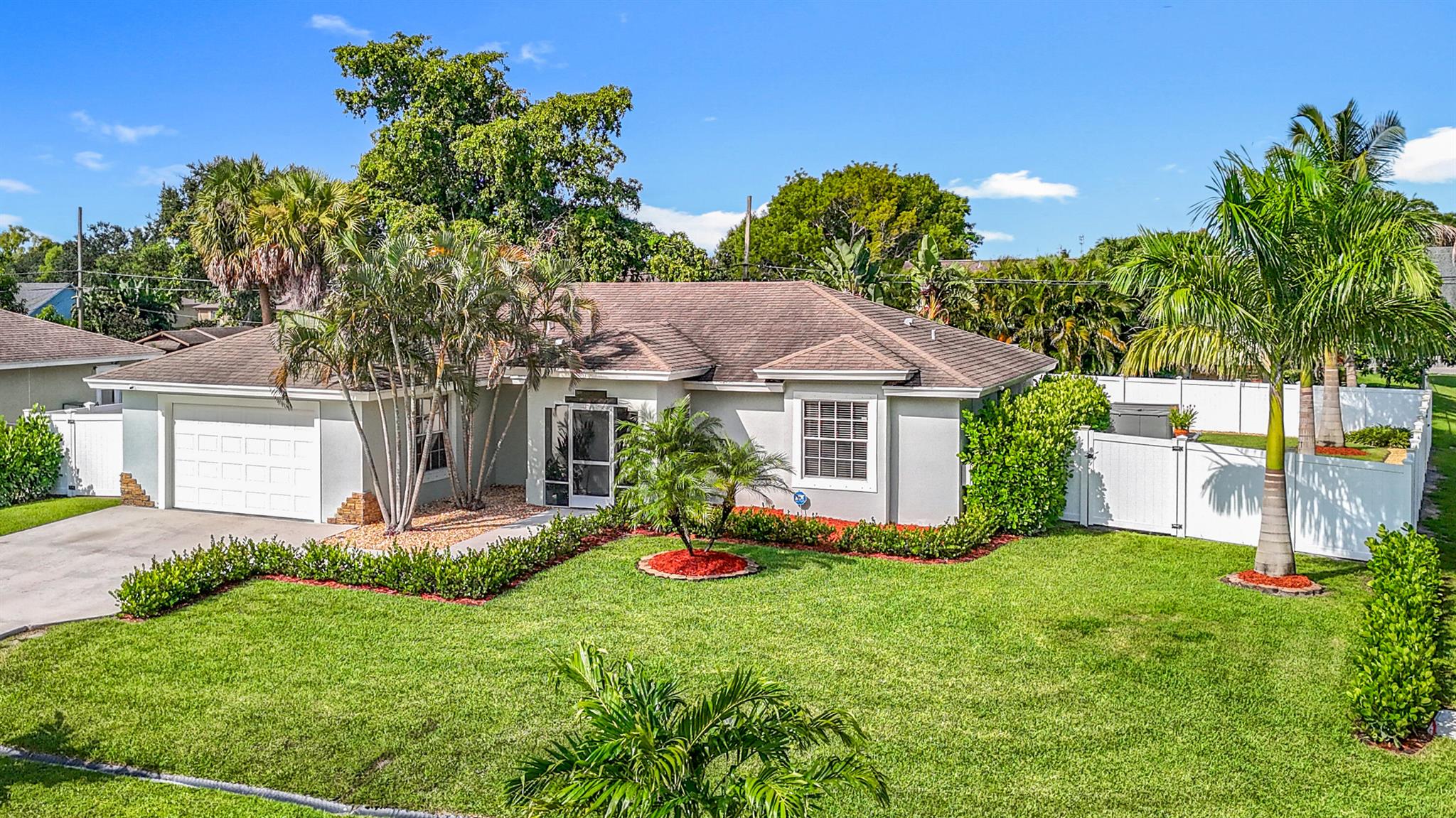Step into a completely remodeled home on an oversized corner lot with NO HOA in the center of Port St Lucie...Brand new kitchen, modern spa-like bathrooms offering floor-to-ceiling tile showers with dual vanities, and wood look flooring and tile throughout the entire home. White PVC fencing for maximum privacy with a HUGE backyard, a hot tub, shed, a fenced 'puppy-pad' for furry friends in training, dual gazebos, and tropical landscaping/professional irrigation completes this turnkey gem!