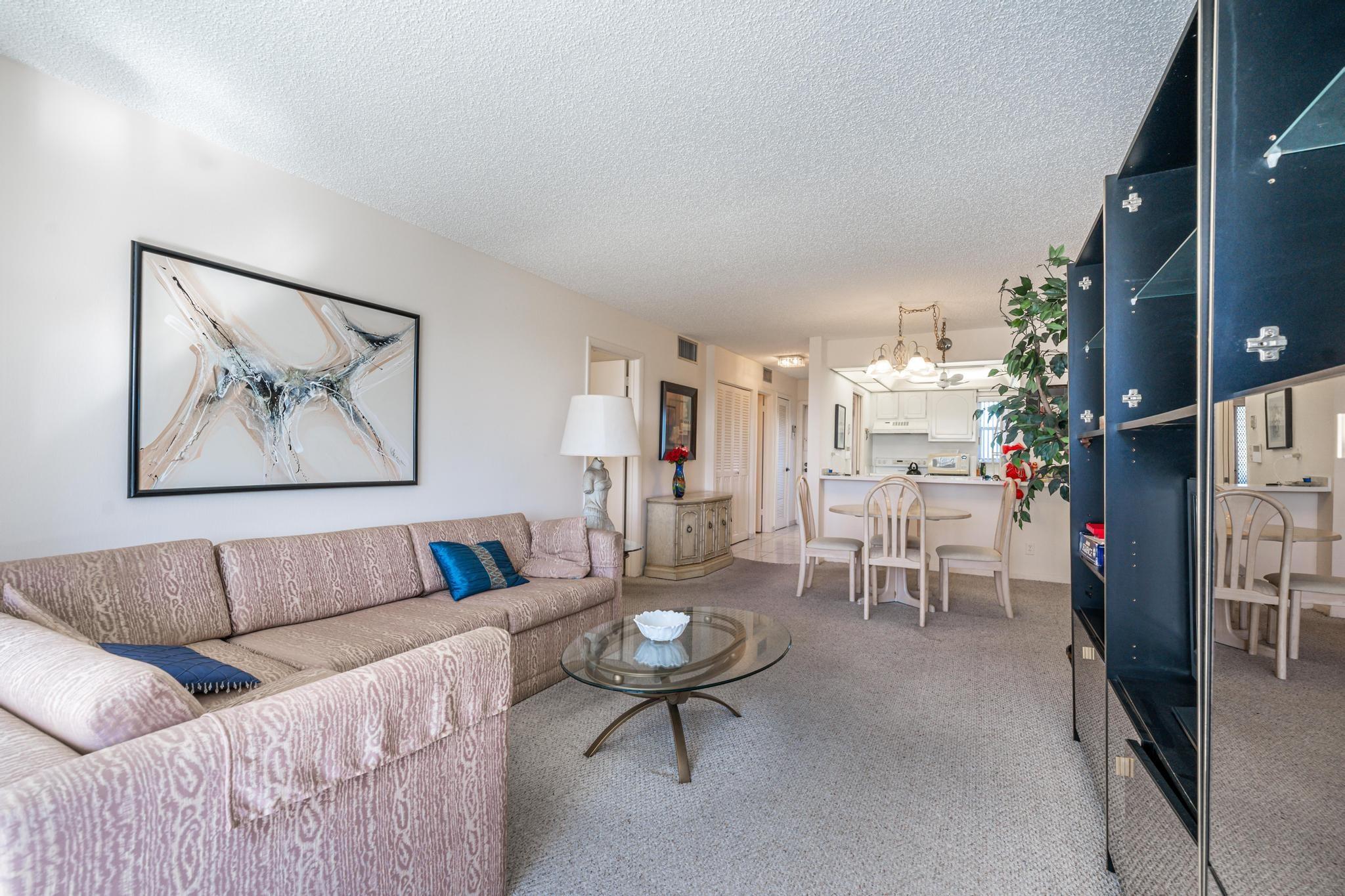 MAGNIFICENT PGA GOLF, TENNIS, POOL & LAKE VIEWS! Convenient 5th Floor 1BR/1.5BA. Steps to pool, BBQ and clubhouse. Enjoy the sunsets on your screened balcony. Eat-in-kitchen with convenient passthrough to dining room. FULLY FURNISHED! Recreation Lease PAID IN FULL! FREE golf (except cart fees) on two 18 hole courses (PGA & Par3); Amenities include Restaurant, Billiard Room, Bbq/Picnic Area, Clubhouse, Courtesy Bus, Exercise Room, Heated Pool, Library, Putting Green, Sauna, Shuffleboard, Tennis, Pickle Ball, Vehicle Wash Area, Electric Car Charging Station. Close to shopping, dining & highways. 15 min. to the beach. Association says 55+ age required; YOU'LL LOVE IT! MOVE RIGHT IN!
