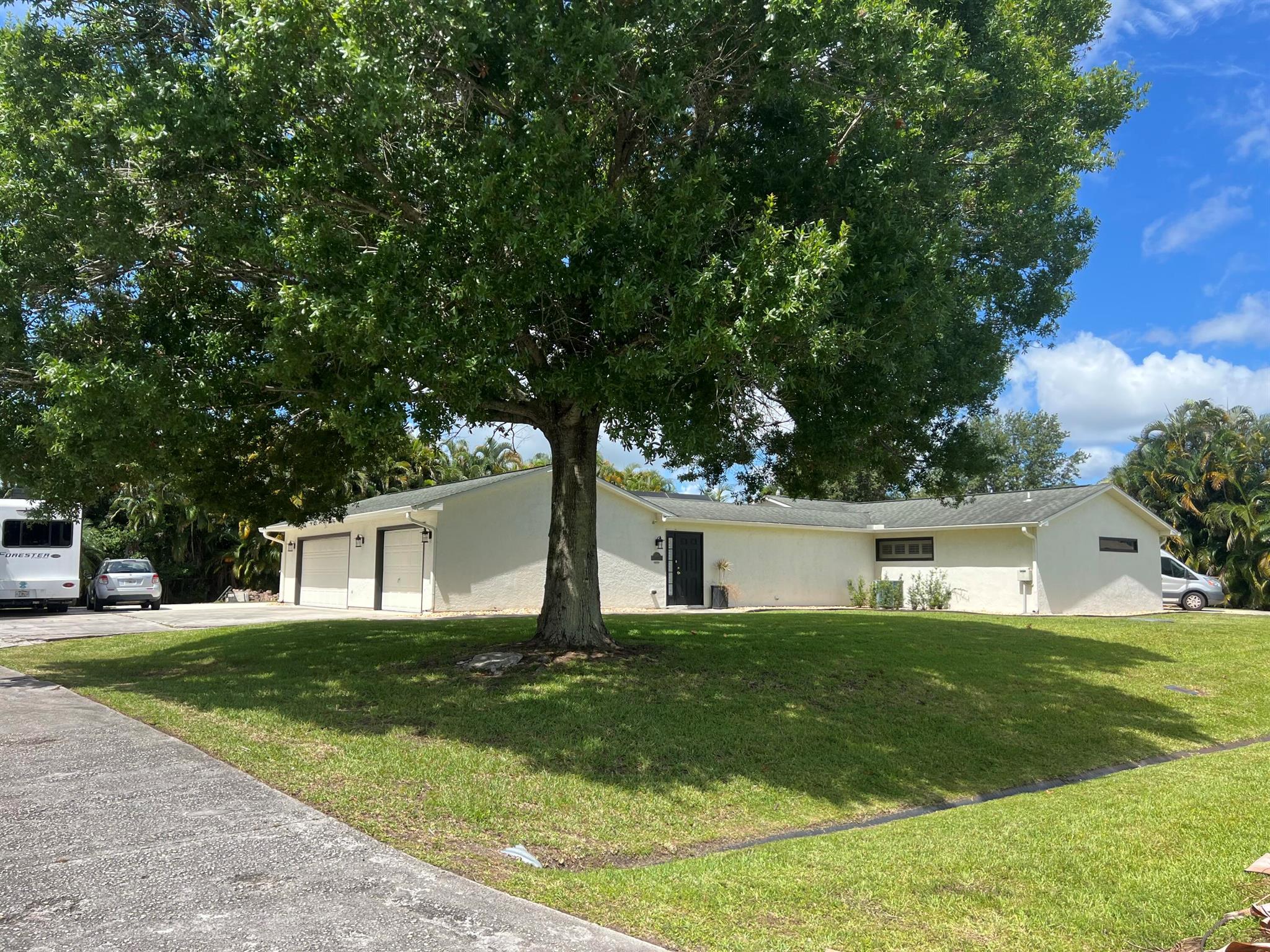 Come discover this single-family POOL home on almost HALF AN ACRE in Port St Lucie! DOUBLE LOT! No HOA or CDD fees! 2 MASTER BEDROOMS! Updates include a newer kitchen with gas range, 3 updated bathrooms and brand new plantation shutters throughout. Neutral tile also throughout, no carpet. This home also features double driveways with plenty of room for multiple boats, RV's and other hobbies. An expansive 3 car garage with a new AC system for your model cars or additional living space! Enjoy year-round peace of mind with a whole-house Generac Whisper Quiet 48kw Generator with all new wiring in 2024! HUGE master bedroom (21x14) with a large walk-in closet and an oversized jacuzzi tub & frameless shower in the master bath. AC 2021, Garage AC 2024, Roof 2004, WH 2022, Pool System 2025.