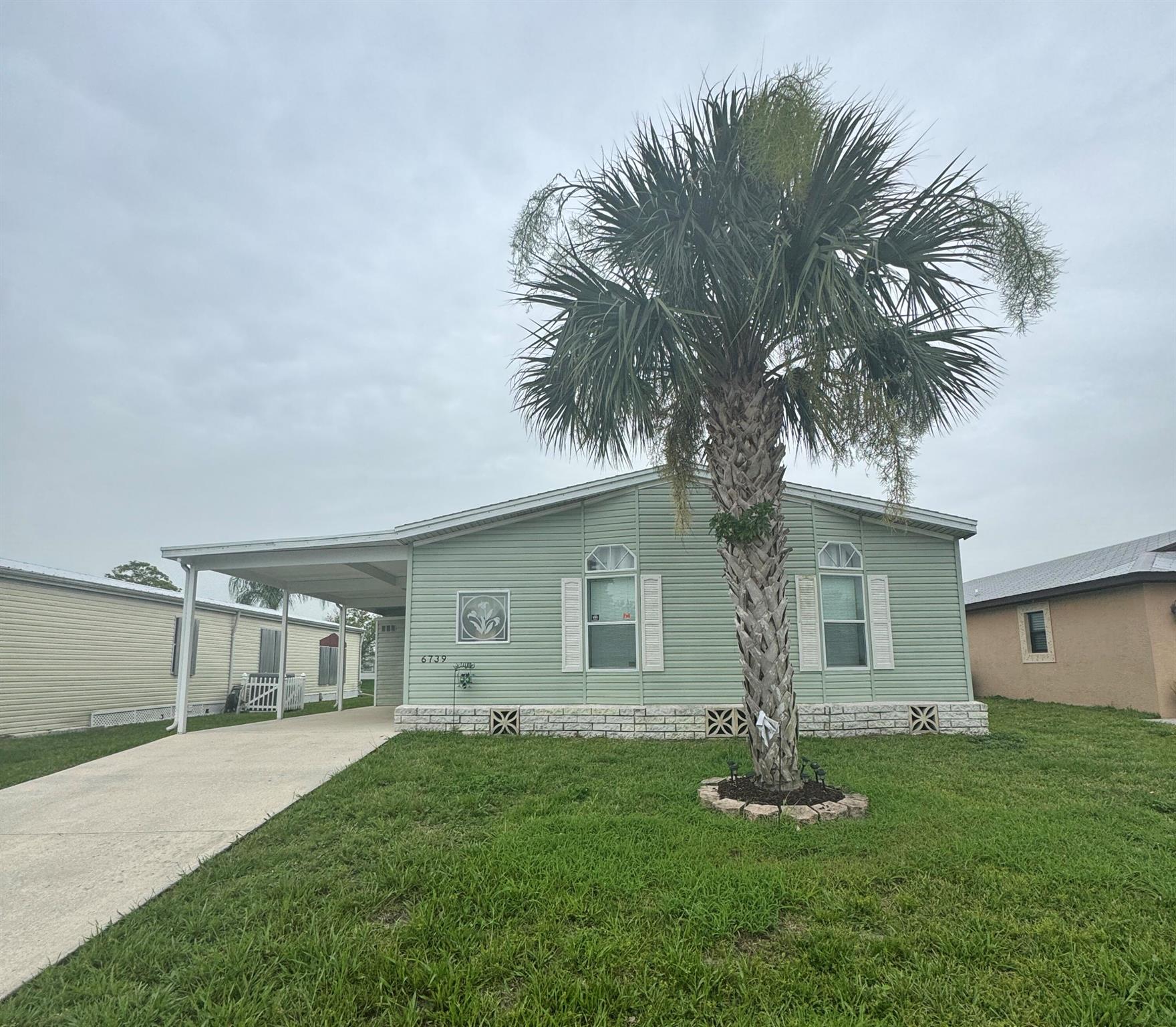 Lovely 2 bedroom 2 bath home with a den.Home is located in the desirable 55+community of Spanish Lakes Fairways. Home has laminate flooring through out. No carpet. This spacious home has an open kitchen with island. New cooktop and refrigerator. Primary bedroom has over sized walk in closets. Primary bathroom has double sink vanity with upgraded showers and tub. Guest bathroom has upgraded raised vanity. Water heater is 2025. Washer and dryer 2025. Home has lovely screened in patio great for morning coffee or evening cocktails. Patio over looks the lake. Laundry room inside home Furniture is negotiable. Lawn care and trash removal included in lot rent. 2 pools, tennis, 18 hole golf course, pickleball, bocceball, shuffle board. club house and much more