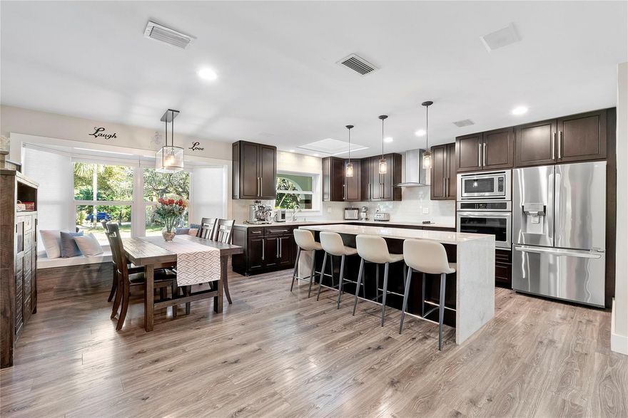 3 Acres in Parkland with 7 bedrooms & 7 bathrooms, When you walk into this spectacular home you will enter into an open floor plan of living space & many open rooms for all the family's entertainment, Remodeled & designed with 2 identical cottages built & attached with a private gym in 2019, Complete newer electrical & plumbing systems throughout, Hurricane impact windows & doors, Custom walnut kitchen w/center island & granite countertops, Top of the line appliances, Italian designer luxury closets, laminate wood & porcelain flooring, Floating vanities, private soccer field, RV/Boat/Tractor Hanger or can convert into stables, Huge Gazebo area 1200 sq feet of entertaining BBQ & Pizza oven space for parties/meetings/luncheons/training or can convert back into a barn, A+Schools,walk to parks Move-in-ready luxury estate offering privacy, space, and versatility on approximately 3 peaceful acres. This exceptional Parkland property showcases designer-appointed interiors, resort-style pool and entertainment pavilion, outdoor pizza oven, and abundant RV and boat parking. The main residence features 3 bedrooms, 3 bathrooms, office/den, gym, and open living areas ideal for hosting. Two separate guest residences, each with 2 bedrooms and 2 bathrooms, offer ideal accommodations for multi-generational living or guests. A rare opportunity combining country-style living with modern luxury.