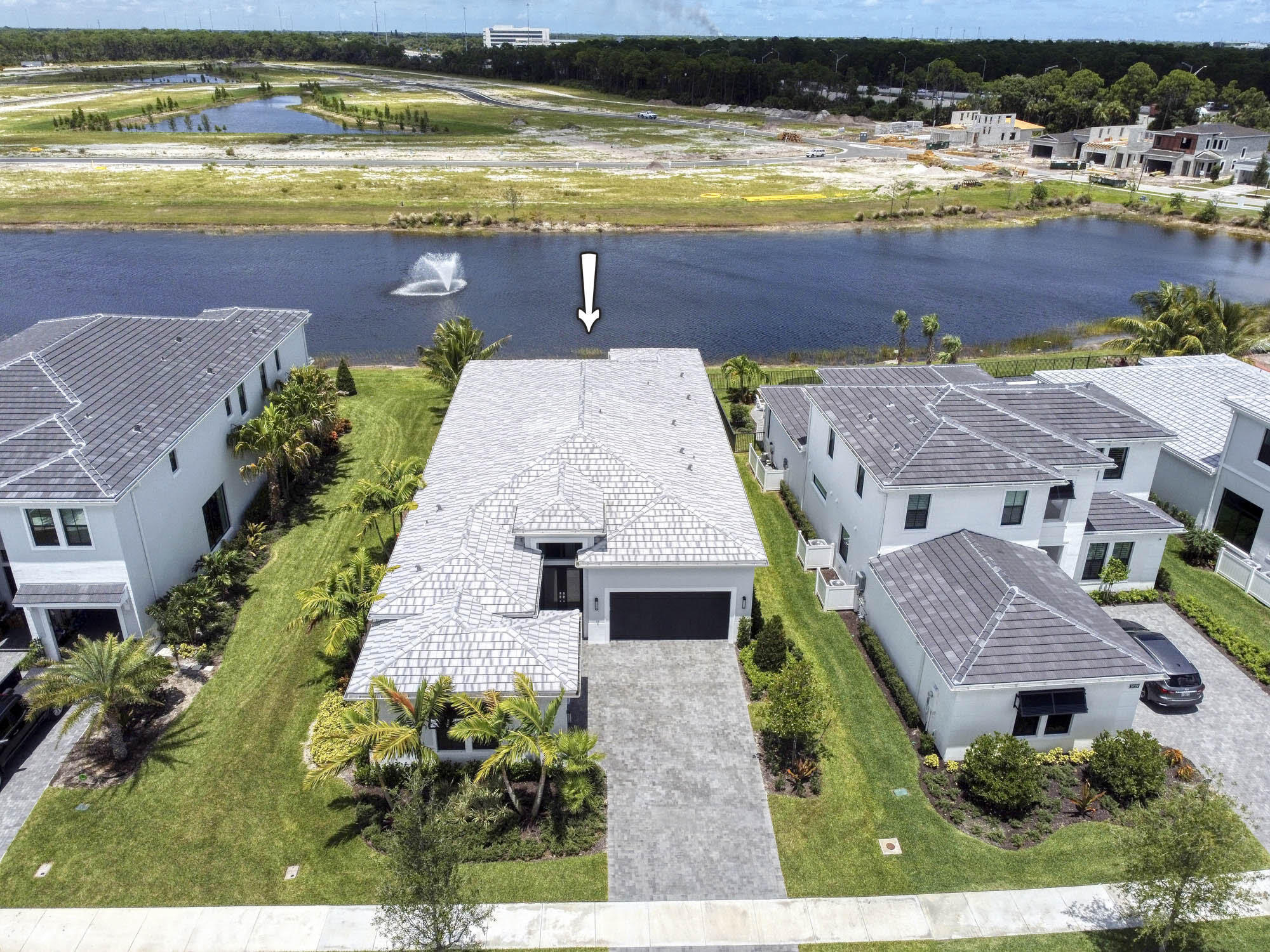 Welcome to this beautiful & luxurious 3BR/3.5BA NEWER BUILD WITH PREMIUM LAKE VIEW home located on a gorgeous lake in the brand-new community of Artistry centrally located in Palm Beach Gardens. This oversized 1-story home has super high ceilings & incredible natural light throughout and has only been lived in for 12 months! The modern kitchen features a huge island, wood floors, brand new appliances, elegant cabinetry, plus a large pantry, The primary suite is located on the 1st floor for maximum privacy and features his & hers walk-in closets with elaborate built-ins, and an oversized luxury bathroom. Each guest room has its own bathroom and walk-in closets, and there's also a bonus 'club room'. The backyard is spectacular and features a lanai with an outdoor kitchen, heated pool,