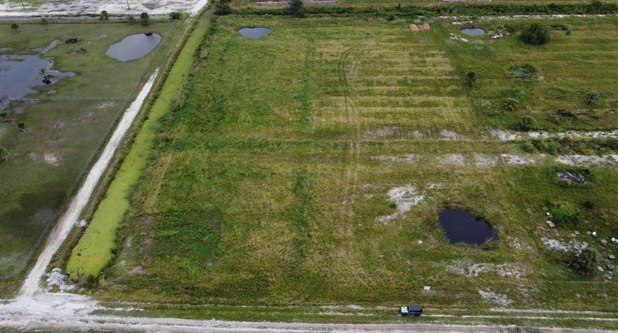 Corner Lot 5.58 +/- acres of sprawling land ready to be yours in one of the fastest growing areas in Palm Beach County. Santa Rosa Groves consists of minimum 5 acre lots and larger and is adjacent to West Lake City. Has an Agricultural Exemption and canals and roads have major improvements underway. Electric is near the property boundary for hookup. This opportunity will not last as there are very few lots available in this community.